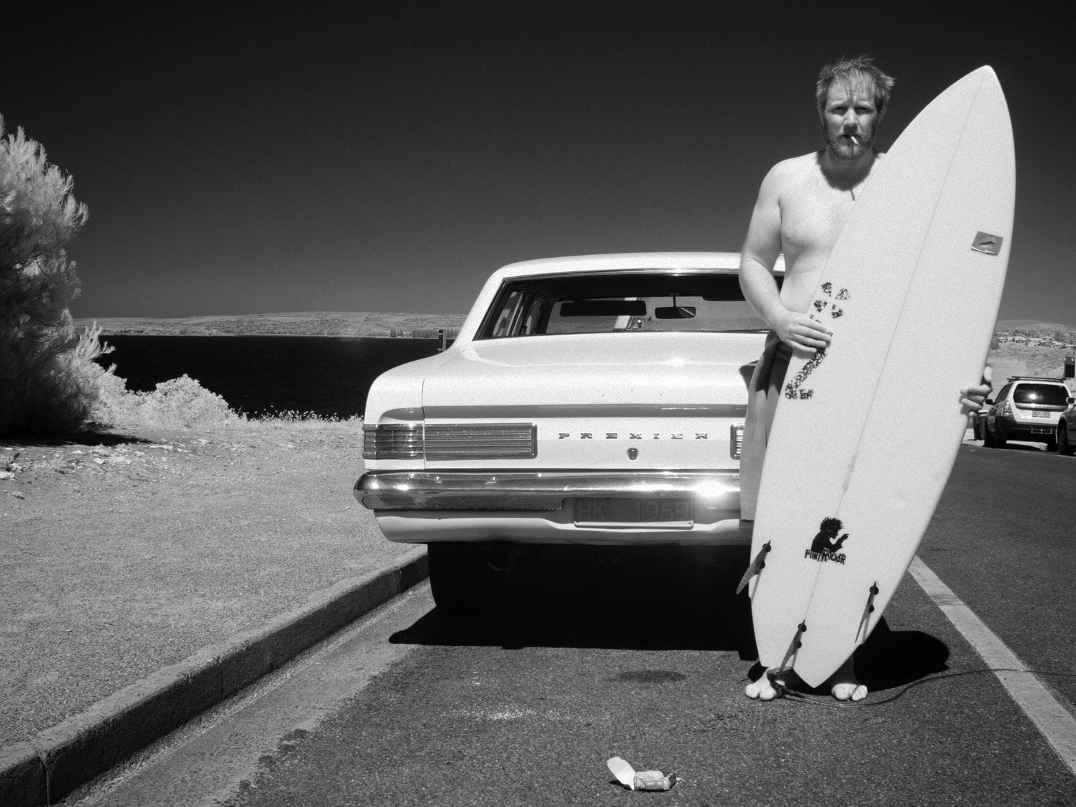 Fine Art Giclee Photograph, Boxed Frame under Museum Grade Glass

A monochromatic image featuring the classic melancholic Aussie surfer with the cherished steed. The image is rife with iconic Australian imagery - from the surfer himself, to the