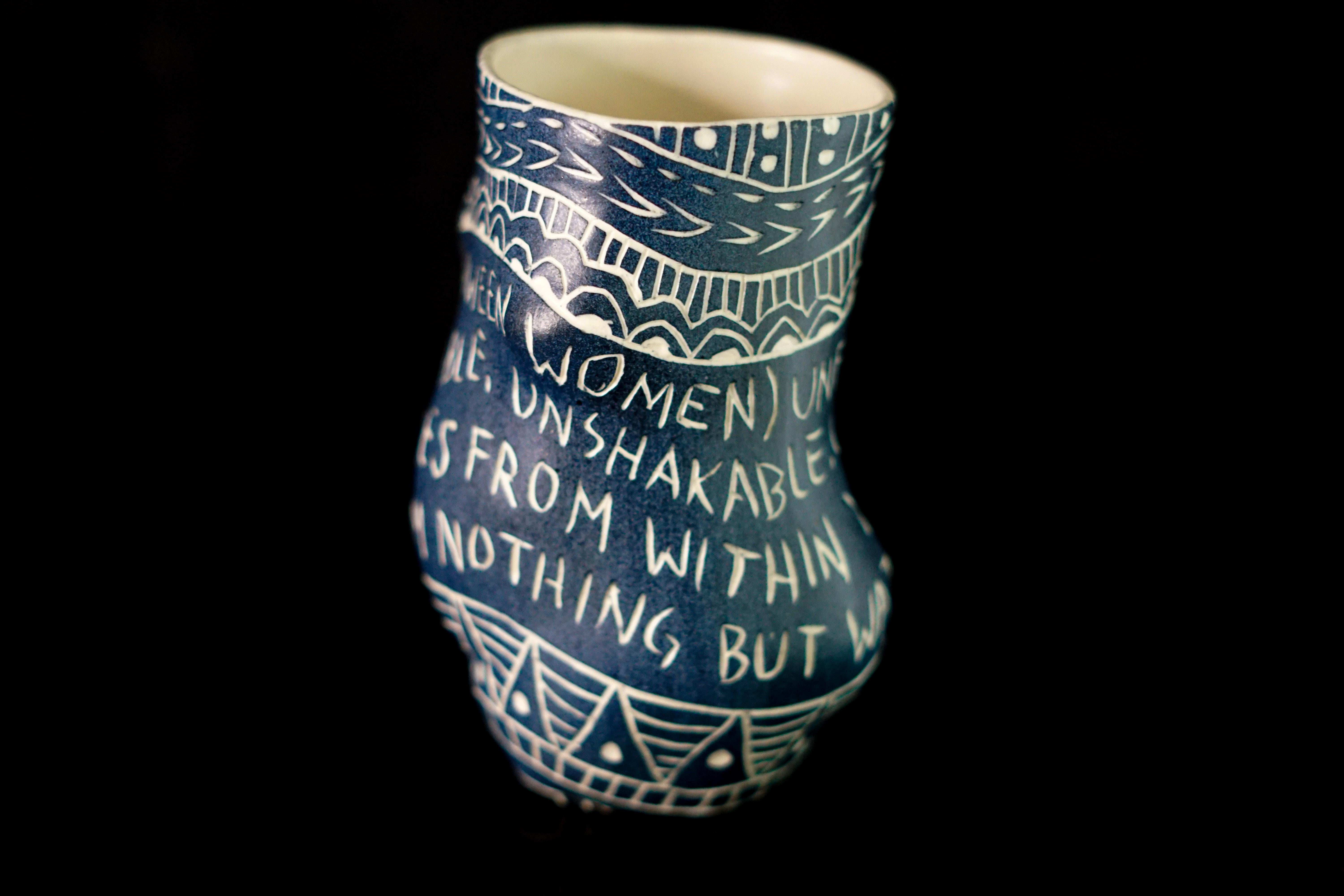 Love (Between Women)…, 2019 by Alex Hodge
Porcelain cup with sgraffito detailing
5 in. x 3 in. W x 3 in.

This cup is one of 48 that make up the installation, “Fragments of Our Love Story.” These cups feature feminine forms which recall the Venus of