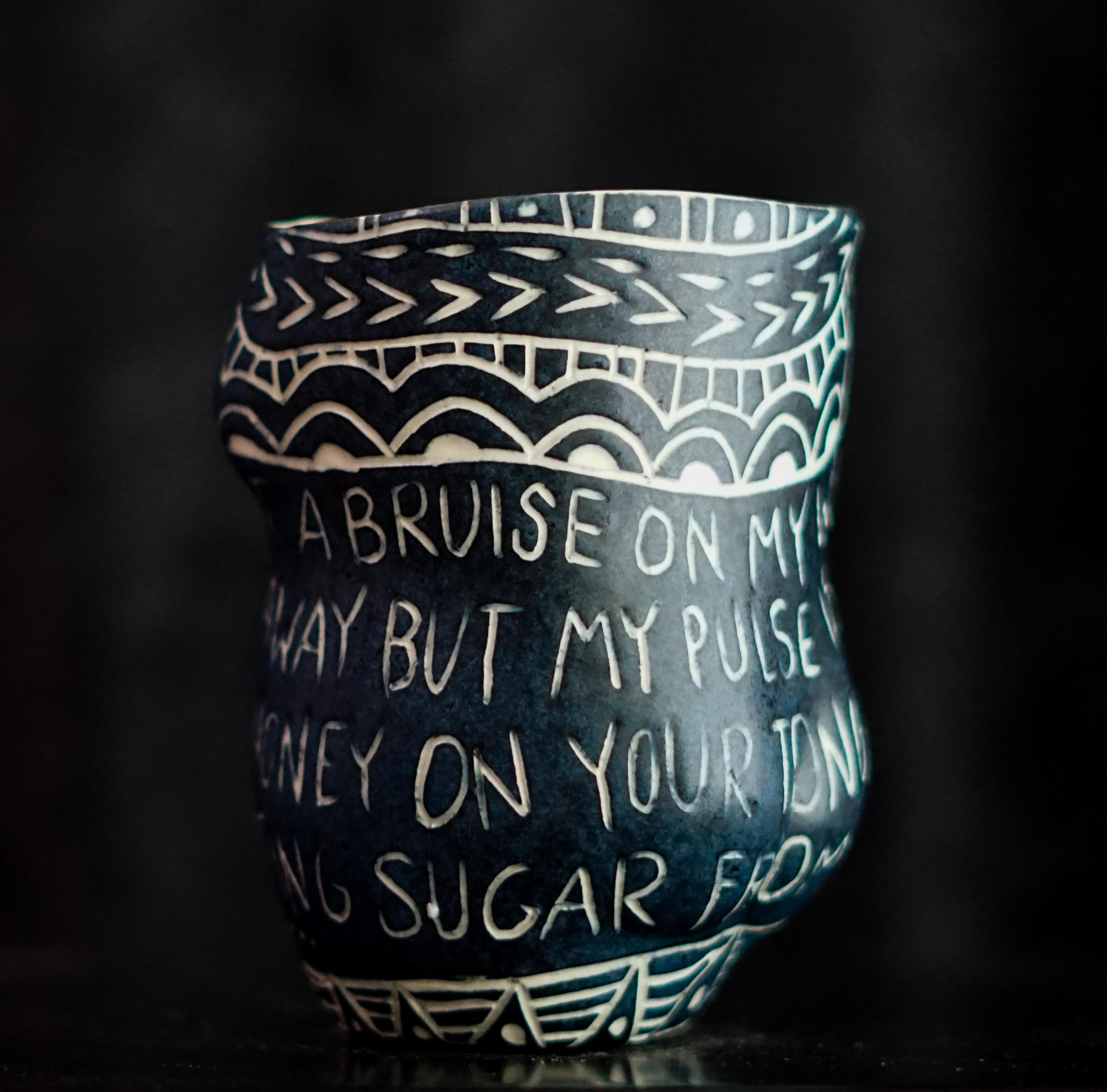 “Your Lipstick Left a Bruise...”, 2019
From the series Fragments of Our Love Story
Porcelain cup with sgraffito detailing
5 x 3 x 3 inches.

“Your lipstick left a bruise..” Your lipstick left a bruise on my wrist. I tried to wipe it away, but my
