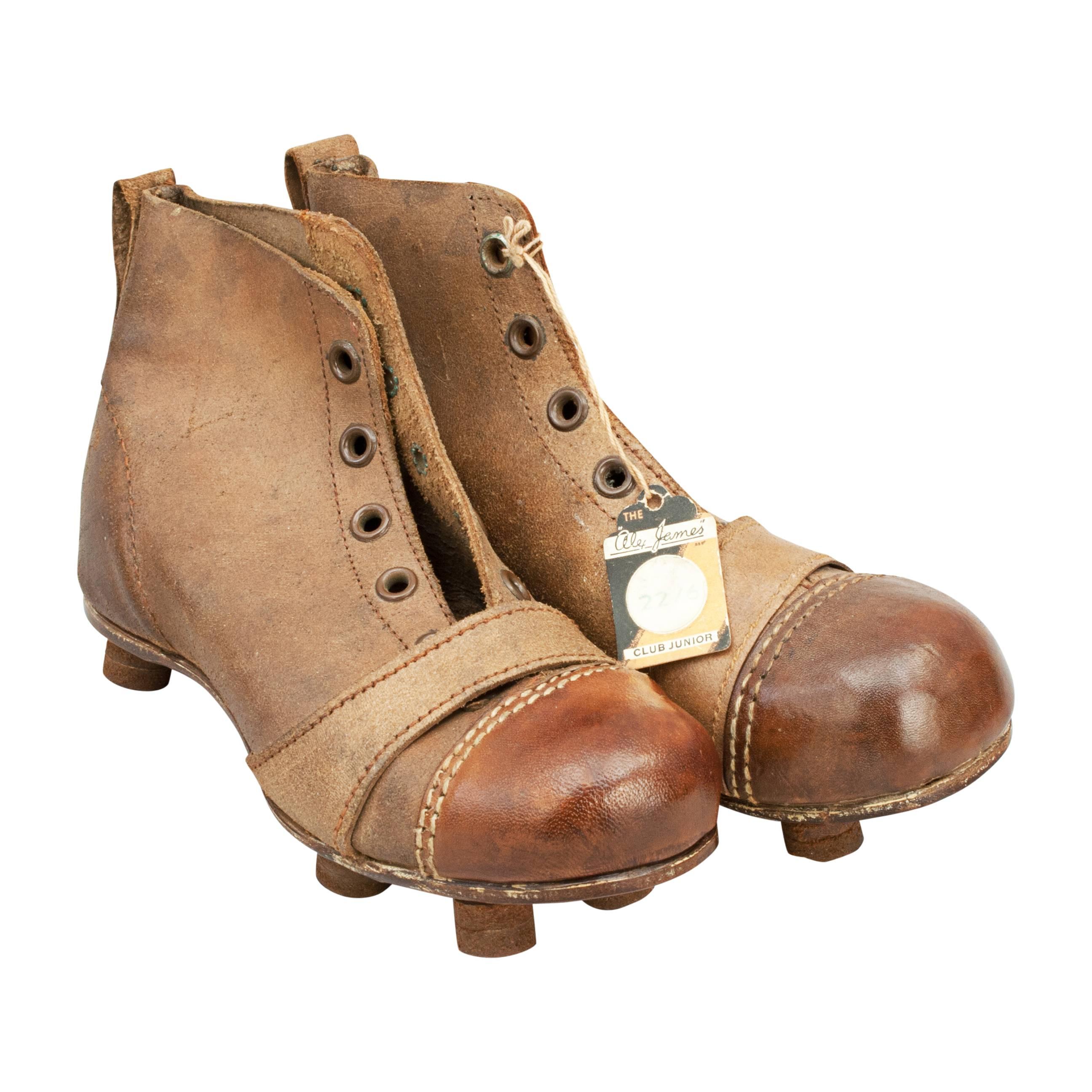Vintage pair of child's leather football boots.
A pair of size 11 unused junior leather football boots. Stamped on the sole with size 11 'The Alex James' with 'Alex James Club Junior' paper label. The toe area on the boots are made of hardened