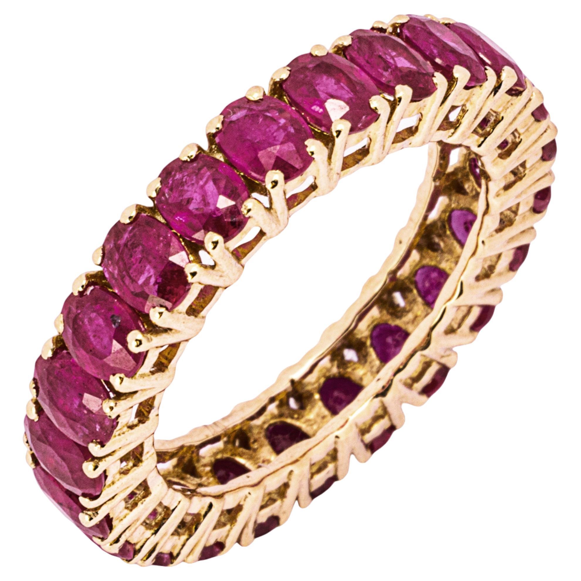 Alex Jona design collection, hand crafted in Italy, 18 karat rose gold eternity band ring, showcasing 23 fine oval cut natural rubies prong-set weighing 4.23 total carats. 
Alex Jona jewels stand out, not only for their special design and for the