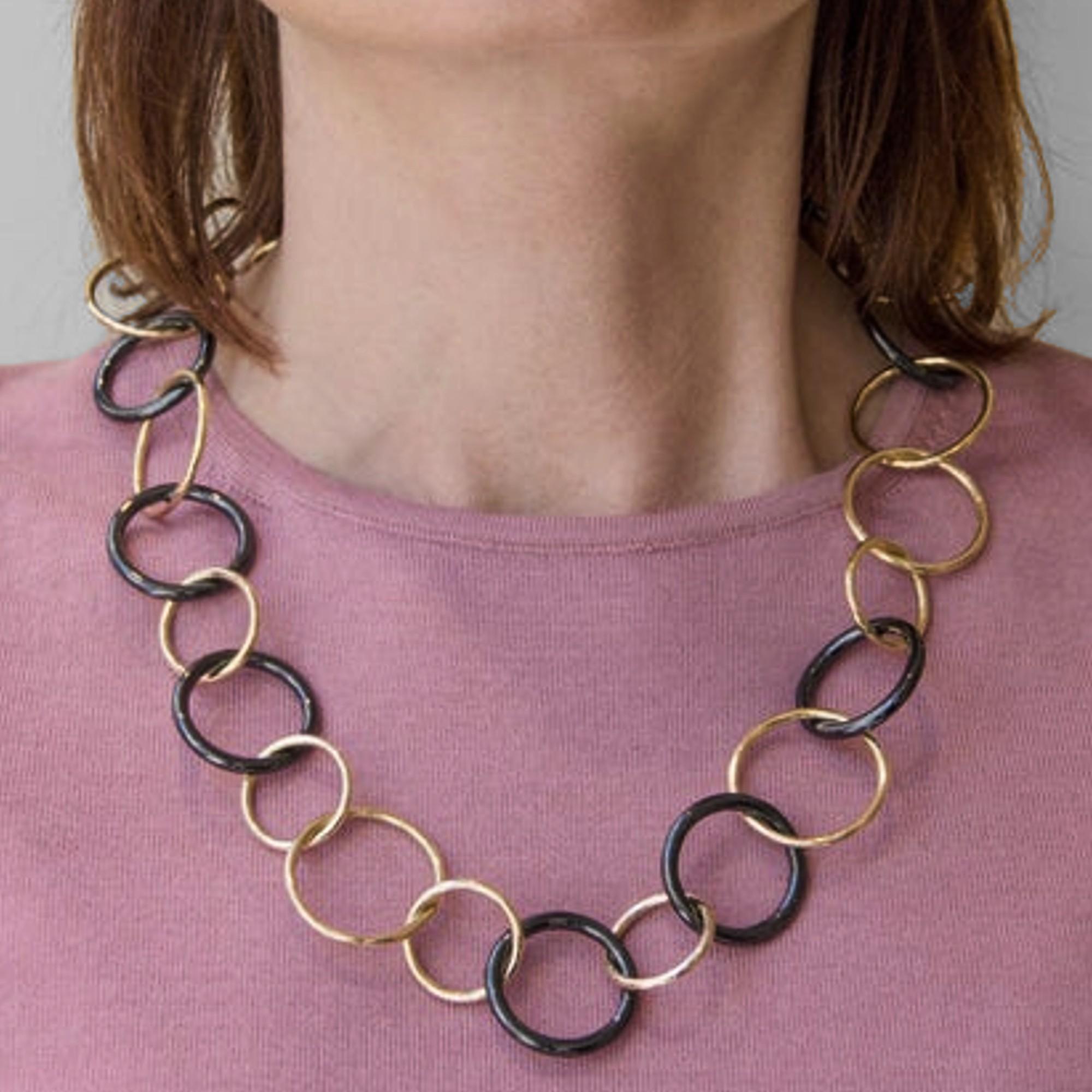 Alex Jona design collection, hand crafted alternating 18k yellow gold and black high-tech ceramic circle chain link necklace. 
Dimension : L 23.43 in / 59 cm 
Diameter  from 0.93in to 1.93in / From 2.36cm in to 4.9cm
With a hardness approaching that