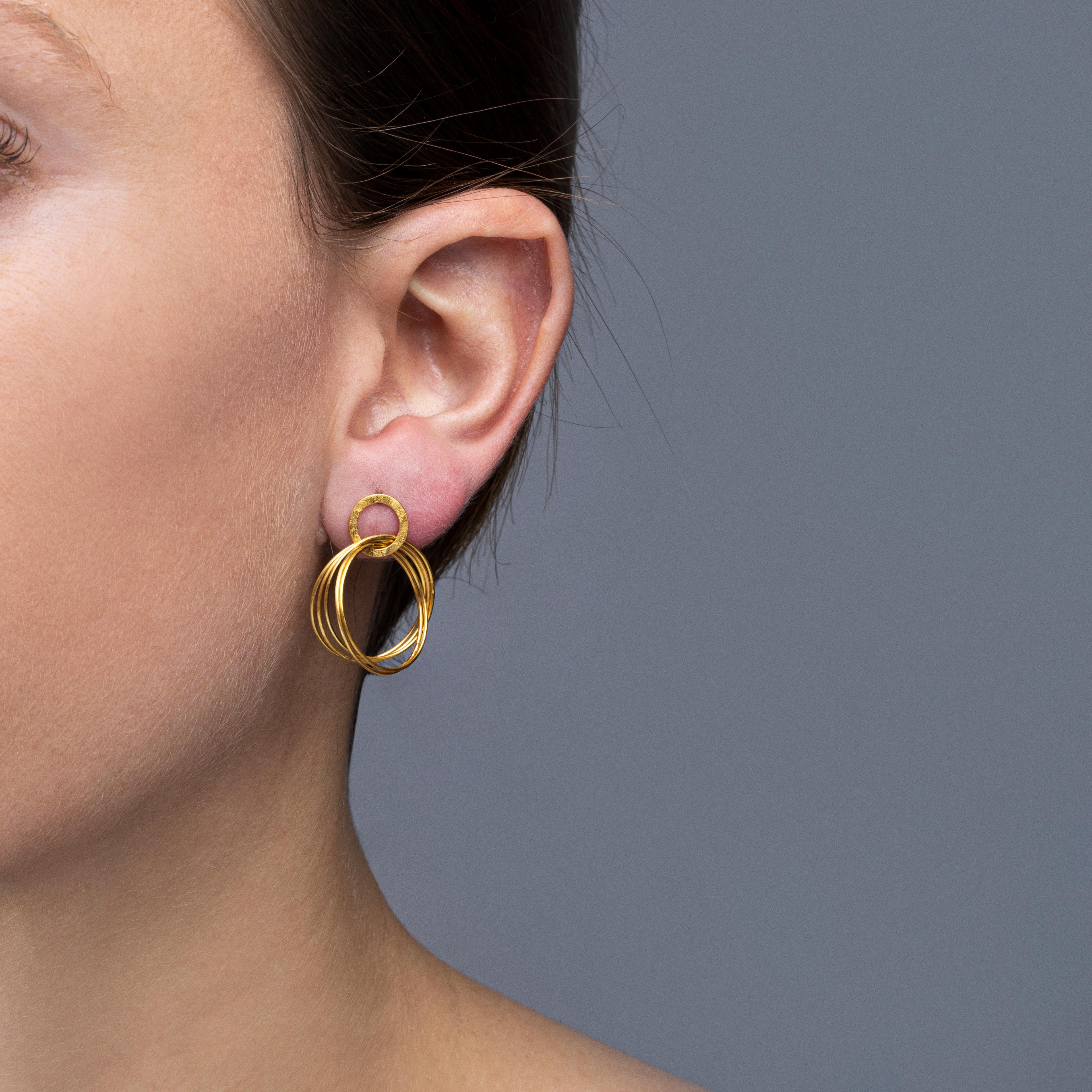 Alex Jona design collection, hand crafted in Italy, 18 karat rough frosted yellow gold multiple hoop pendant earrings.
Dimensions: H 0.75in/19mm, W 0.68in/17mm, D 0.07in/1.8mm.

Alex Jona jewels stand out, not only for their special design and for