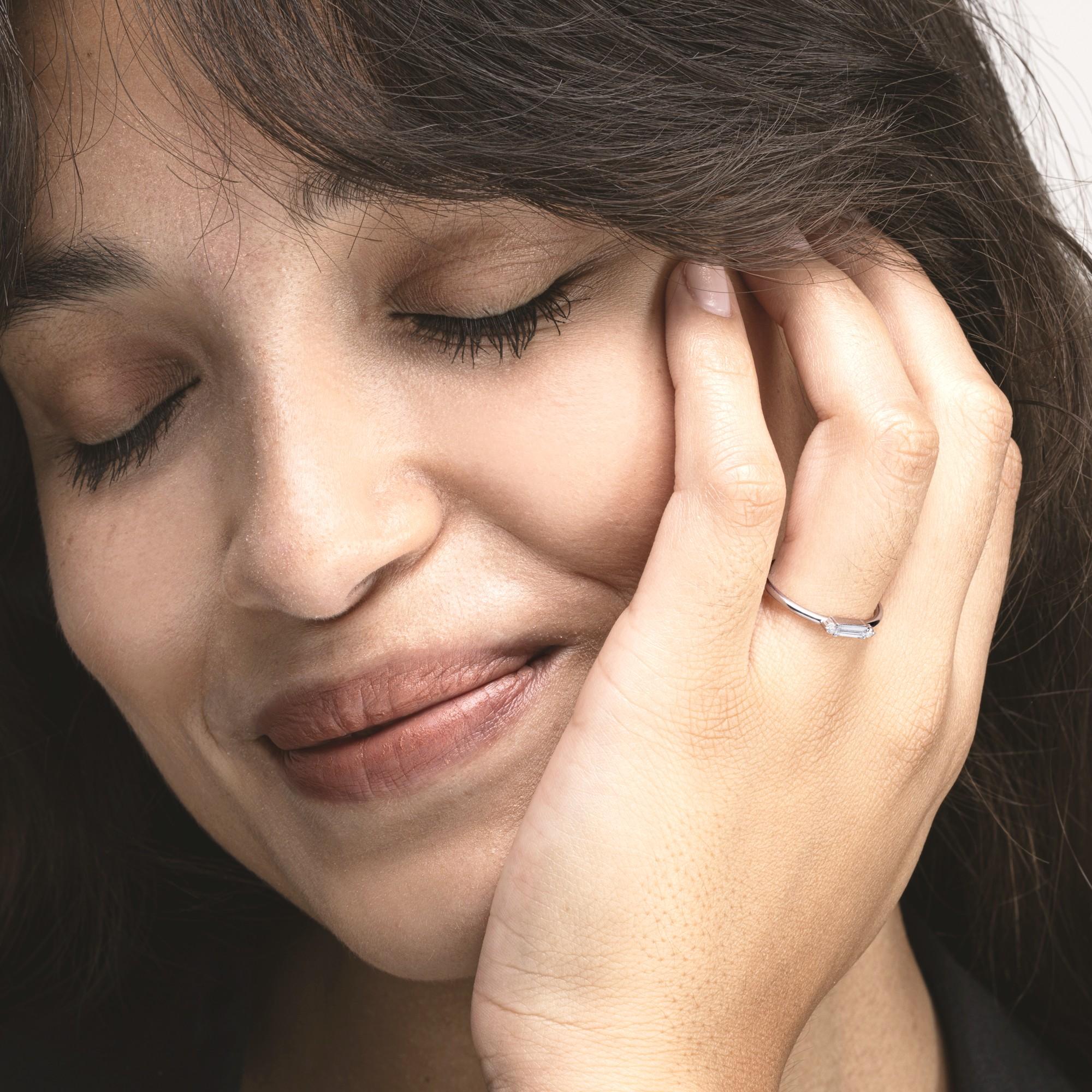 Alex Jona Design collection, hand crafted in Italy, 18 Karat white gold ring centering a baguette cut accented by two white diamonds weighing total carats 0.16.
Alex Jona jewels stand out, not only for their special design and for the excellent