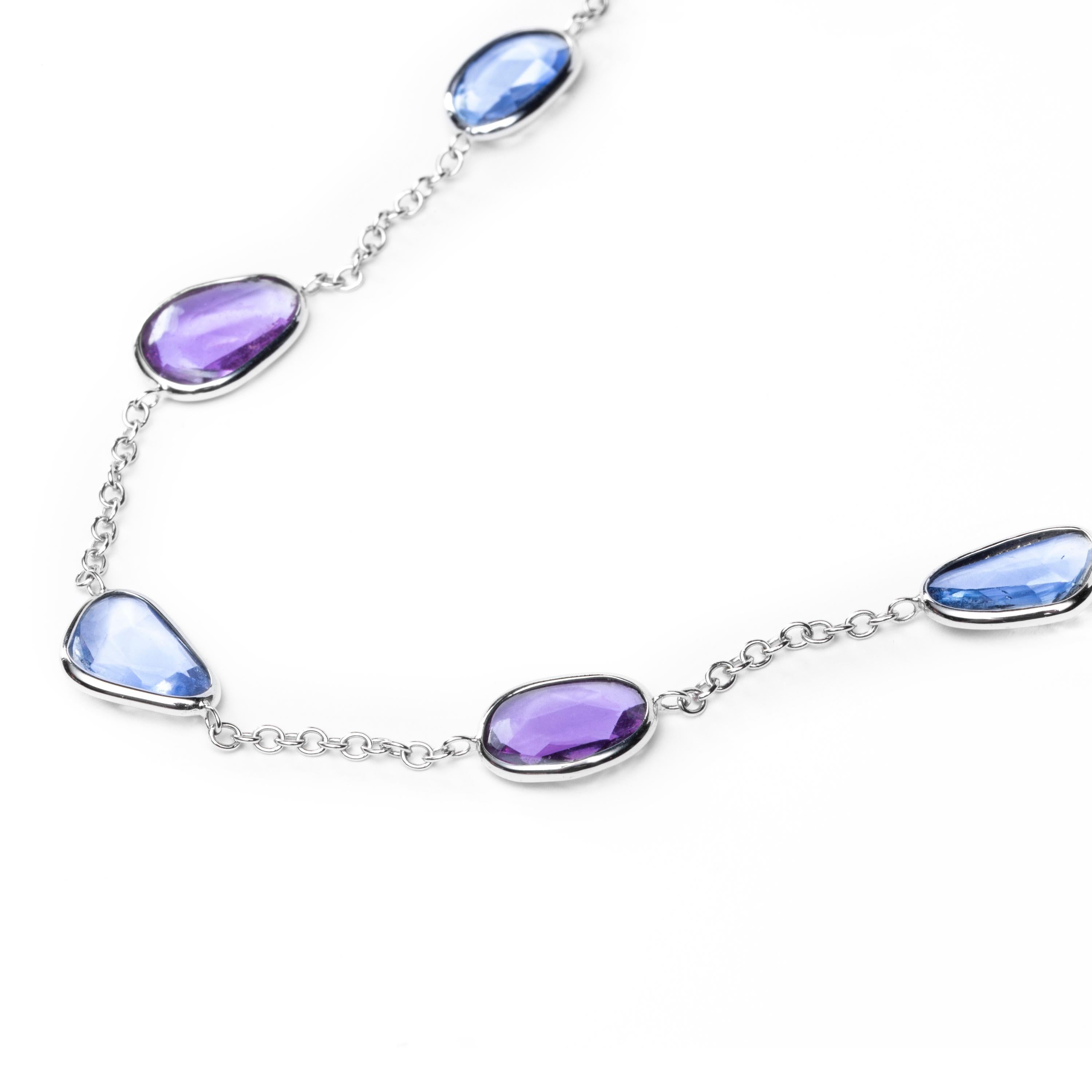 Alex Jona design collection, hand crafted in Italy, 18 Karat white gold chain necklace, 18.11 inch long -45 cm, accented by 7 multicolor flat cut pink and blue sapphires weighing 13.95 carats in total, with bezel-set.
All Jona jewelry is new and has