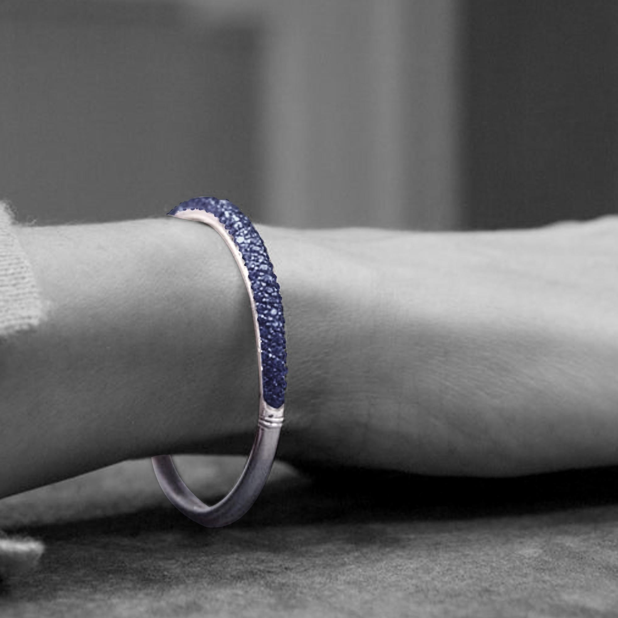 Alex Jona design collection, hand crafted in Italy, 18 karat white gold bangle bracelet set with a blue sapphire pavé consisting of 103 Burmese blue sapphires weight  5.34 carats in total.

Alex Jona jewels stand out, not only for their special