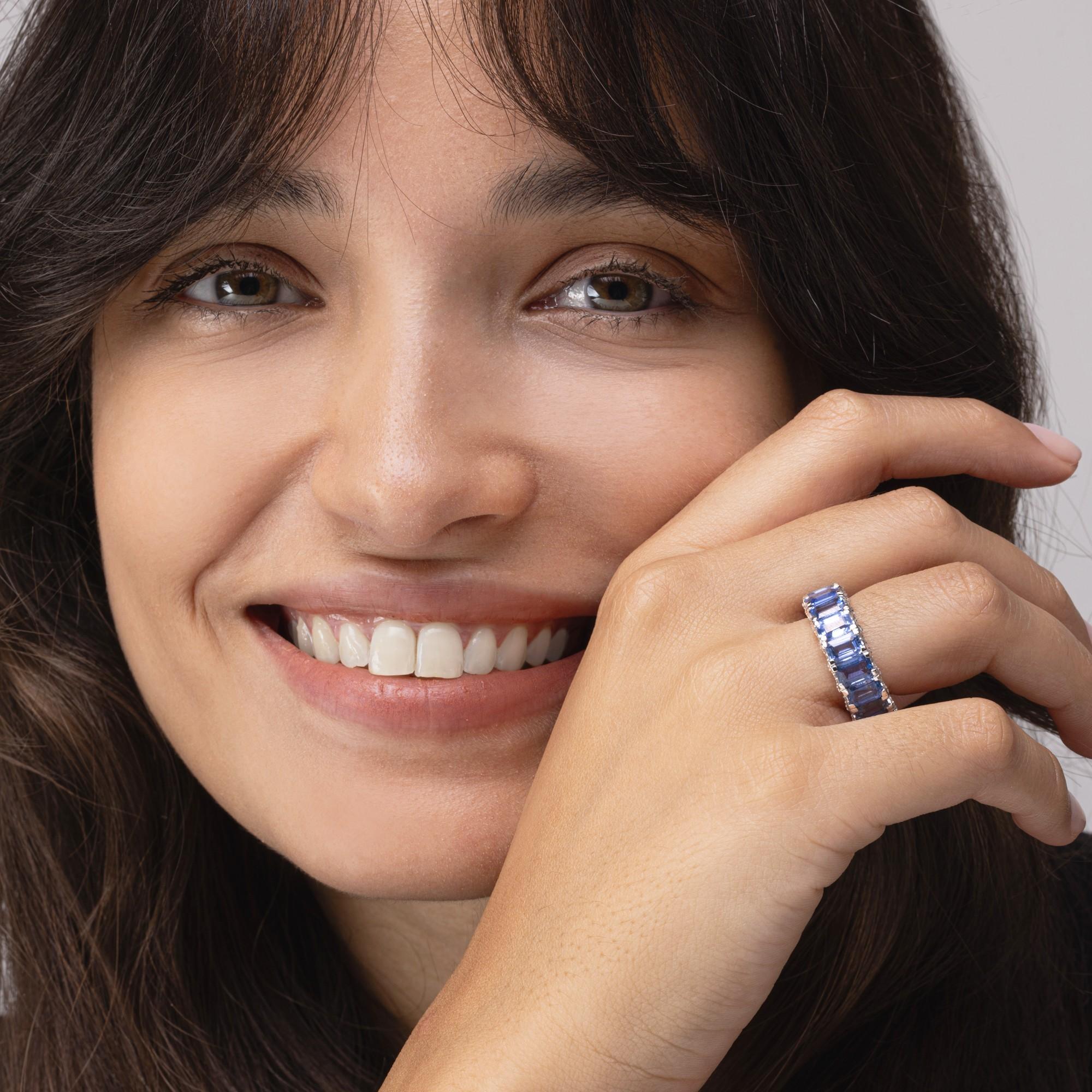Alex Jona design collection, hand crafted in Italy, 18 karat white gold eternity band ring, set with 12.04 carats of emerald cut blue sapphires. Both sides are set with 0.74 carats in total of white diamond festoons.
Alex Jona gifts stand out, not