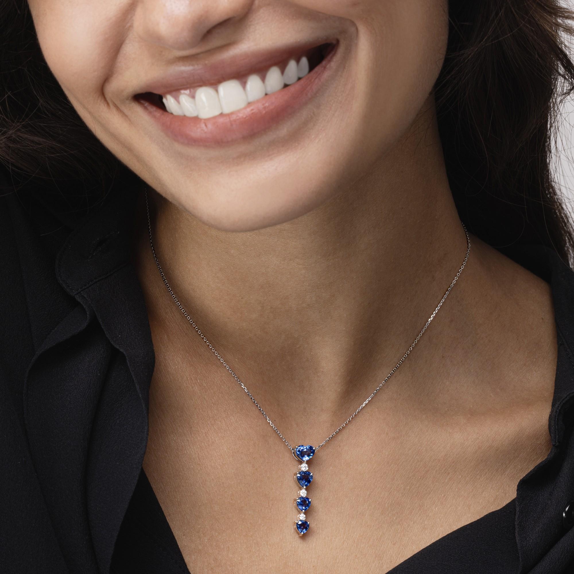 Alex Jona design collection, hand crafted in Italy, 18 karat white gold pendant necklace, 16.5 inch long, suspending four heart cut blue sapphires, weighing 3.31 carats in total alternated by 0.13 carats of white diamonds, F-G color, VS