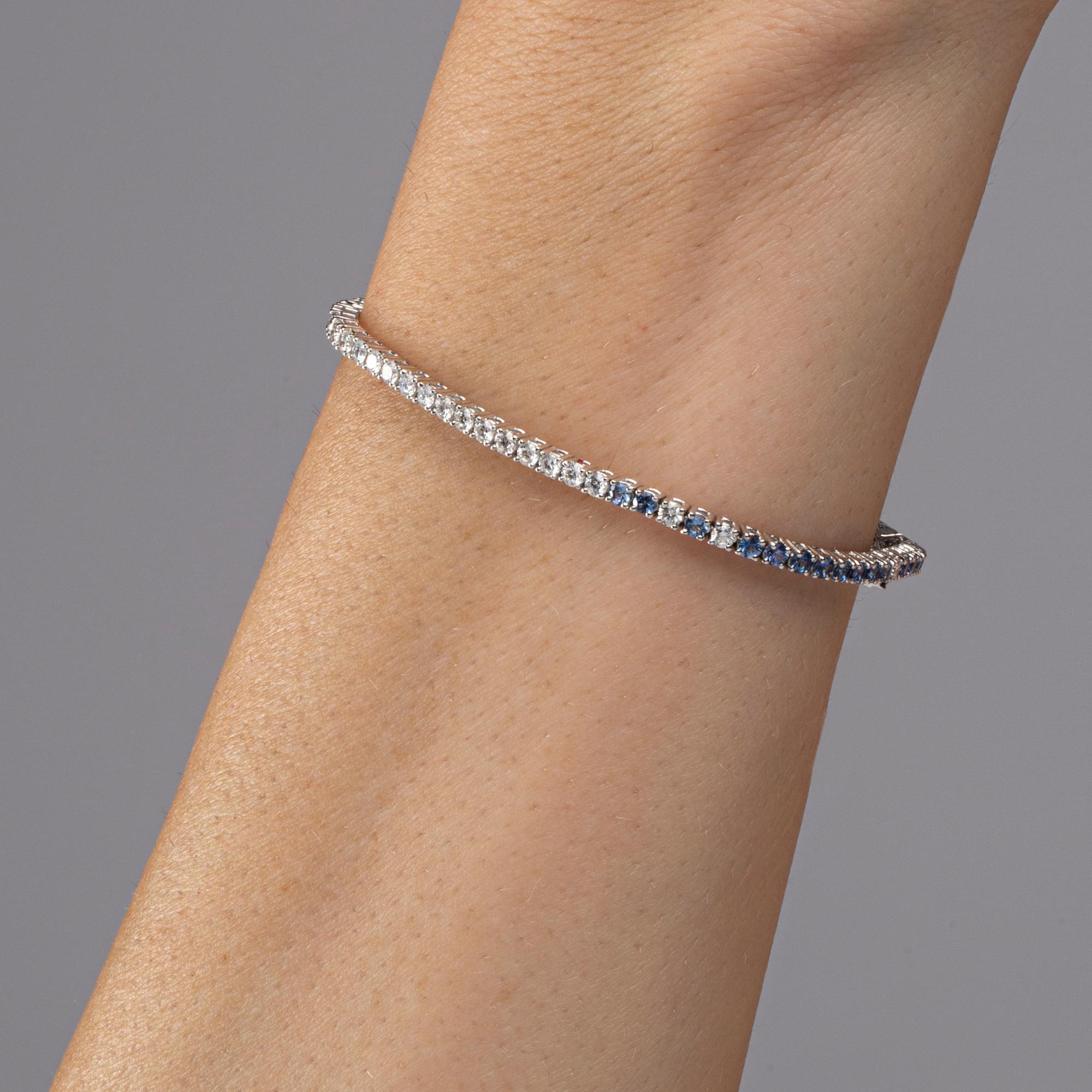 Alex Jona design collection, hand crafted in Italy, 18 karats white gold tennis bracelet 7 in. long, set with 26 white diamonds weighing 1.00 carats in total, alternating with 50 blue sapphires weighing 2.70 carat in total.

Alex Jona jewels stand