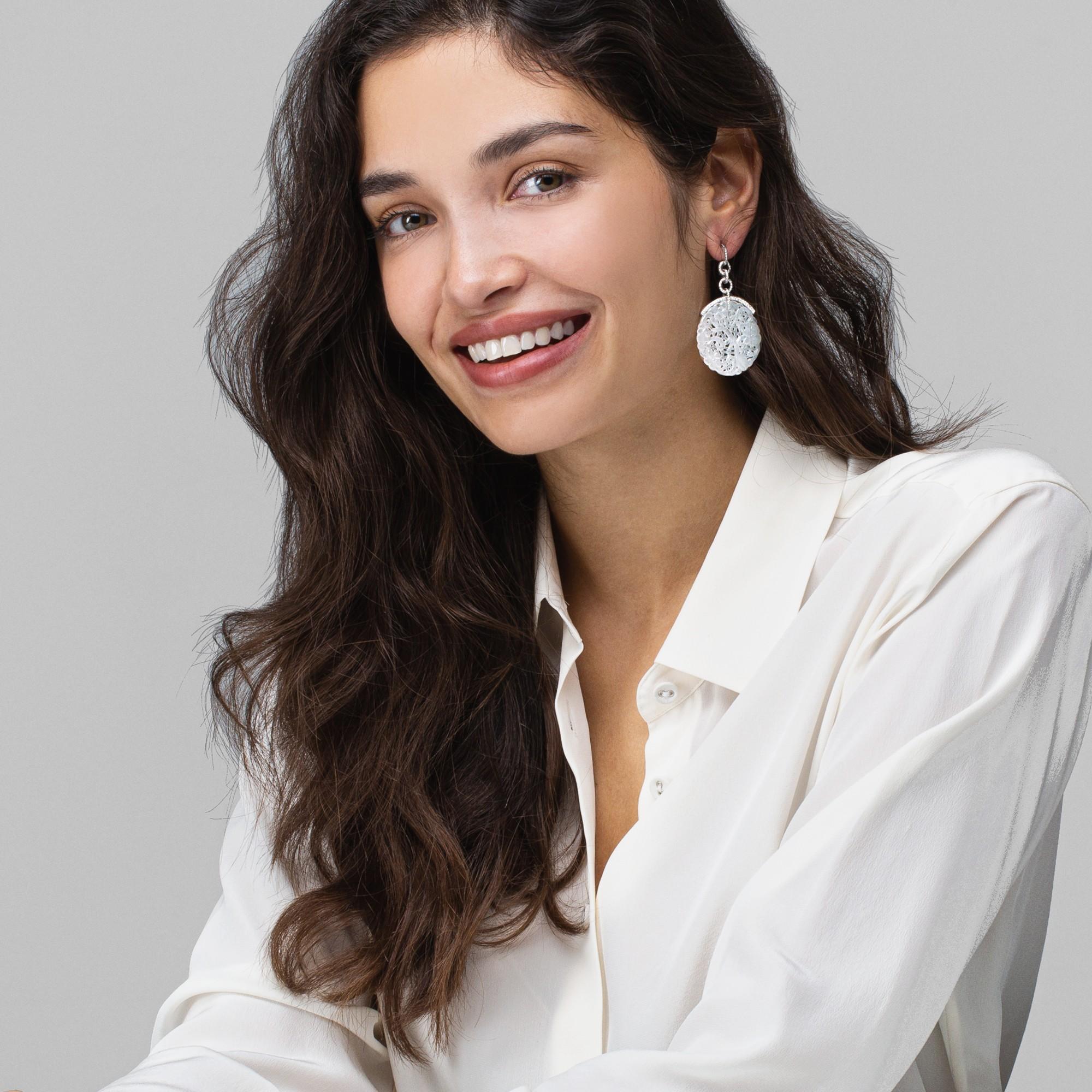 Alex Jona design collection, hand crafted in Italy, pair of dangle earrings suspending two carved white jade discs weighing 38.30 carats in total, set on 18 karat white gold adorned by 0.72 carats of white diamonds, F color, VVS1 clarity.

Alex Jona