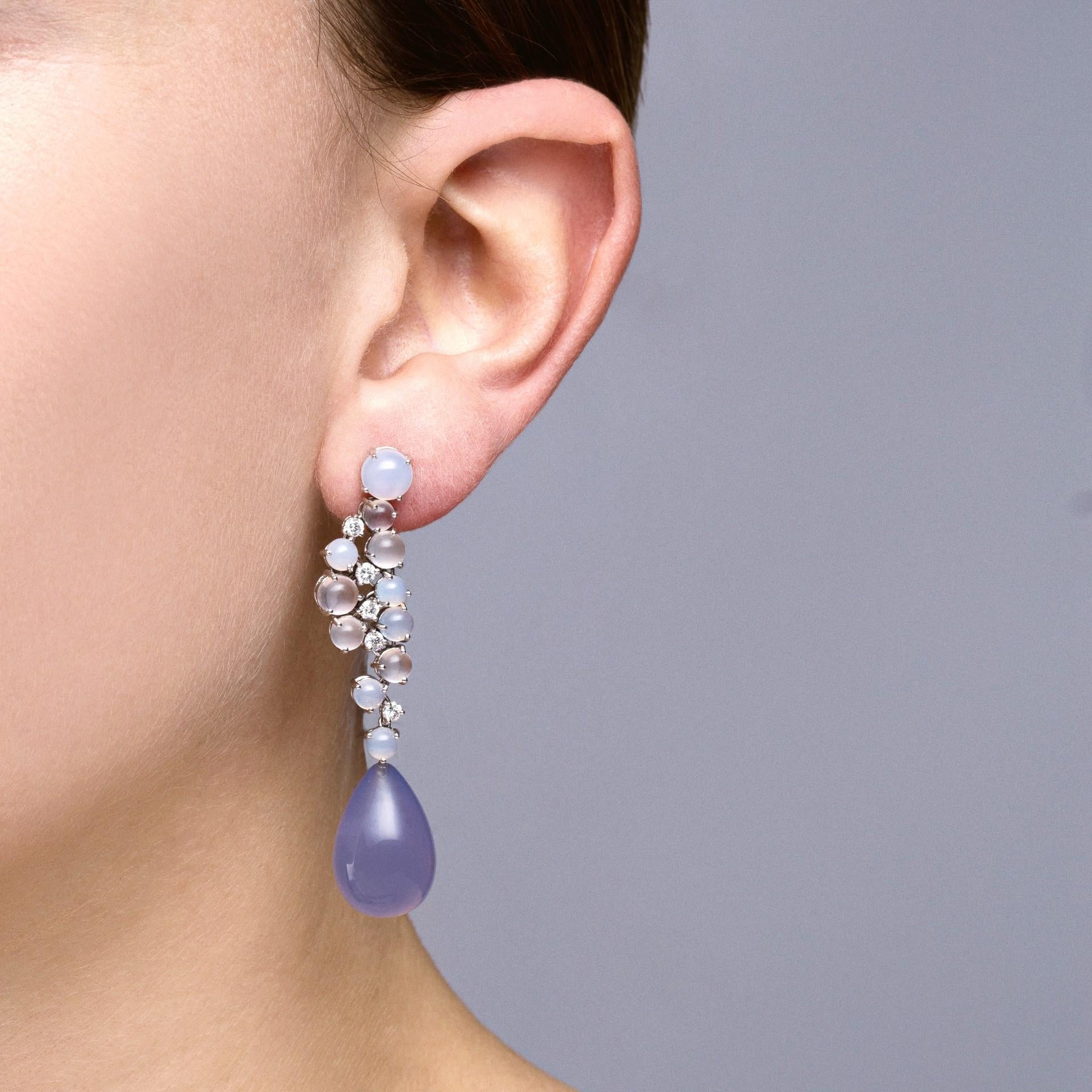 Alex Jona design collection, hand crafted in Italy, 18 karat white gold pair of drop earrings, featuring moonstone and chalcedony cabochons, 0.66 carats of white diamonds and a pair of pear shaped Namibian Chalcedony cabochon drops, weighing 50.89