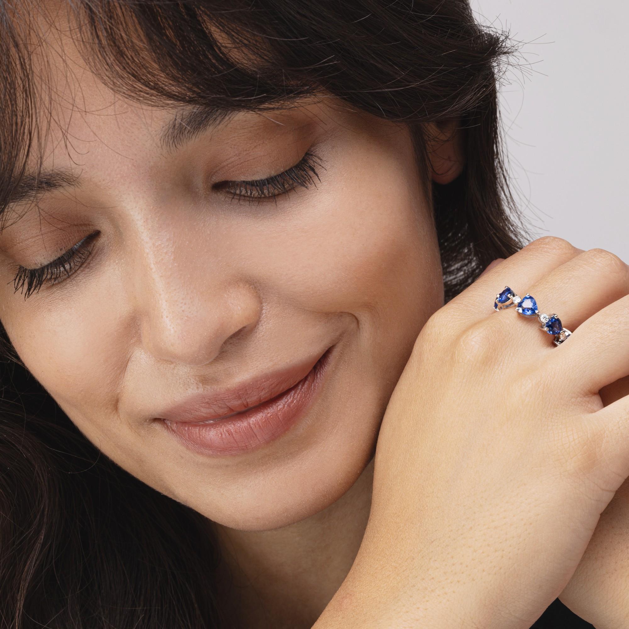 Alex Jona design collection, hand crafted in Italy, 18 karat white gold eternity band ring, set with 9 heart cut blue sapphires weighing 5.25 total carats,  alternating  9 round cut white diamonds of total carats 0.27.

Alex Jona jewels stand out,