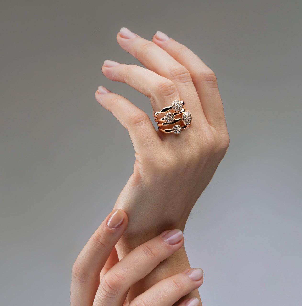 This spectacularly designed ring by Alex Jona features four 18 karat rose gold organic shaped bands forged together and accented with irregularly placed diamond pavé buttons featuring 53 brown diamonds weighing 1.09 carats.
Hand crafted in Italy,