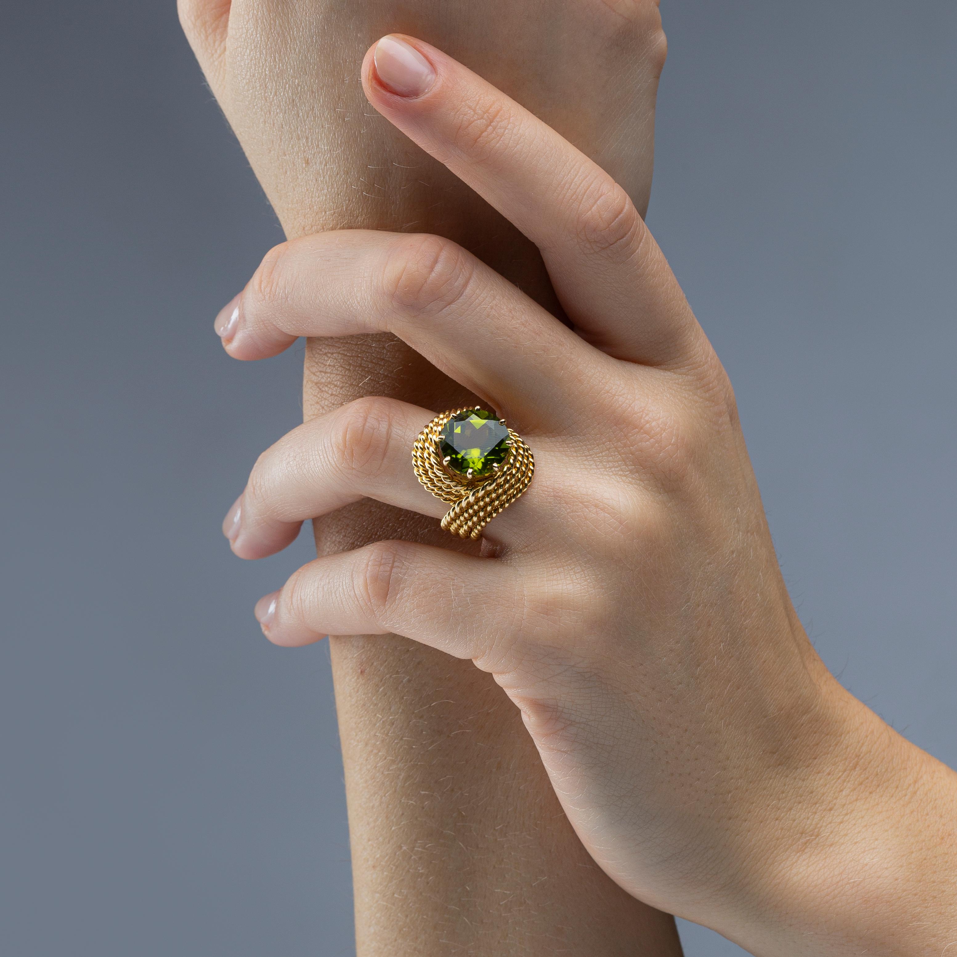 Alex Jona Nounou ring, hand crafted in Italy, 18k yellow gold ring, centering a round cut peridot weighing  6.5 carats; size 5.5, can be sized to any specification.

Alex Jona jewels stand out, not only for their special design and for the excellent