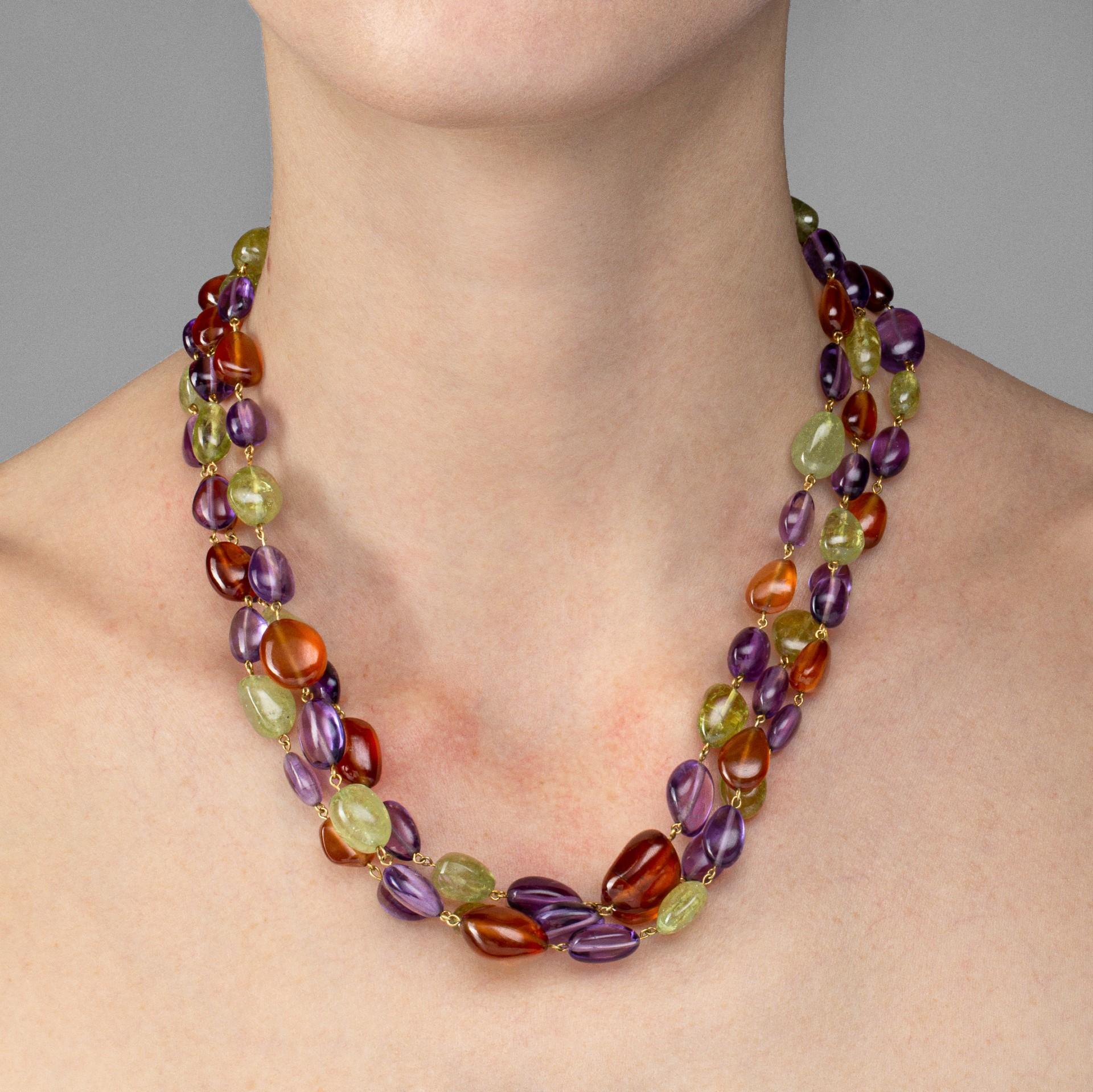 Alex Jona design collection, hand crafted in Italy, 18 karat yellow gold multi-strand necklace, featuring 550 carats of peridots, amethysts and carnelians. Length: 18.5 to 19.3 inch long- 47 to 49 cm long.

Alex Jona jewels stand out, not only for