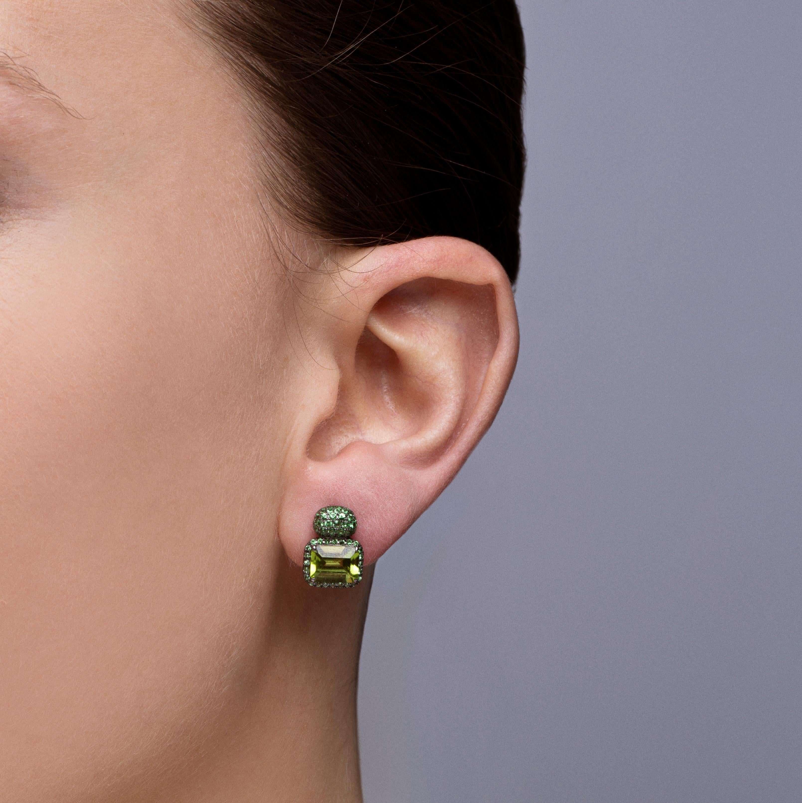 Alex Jona design collection, hand crafted in Italy, 18 karat white gold with black rhodium stud earrings set with two emerald cut peridots weighing 3.35 carats in total, surrounded by 0,79 carats of round cut  tsavorite.
Dimensions: H
