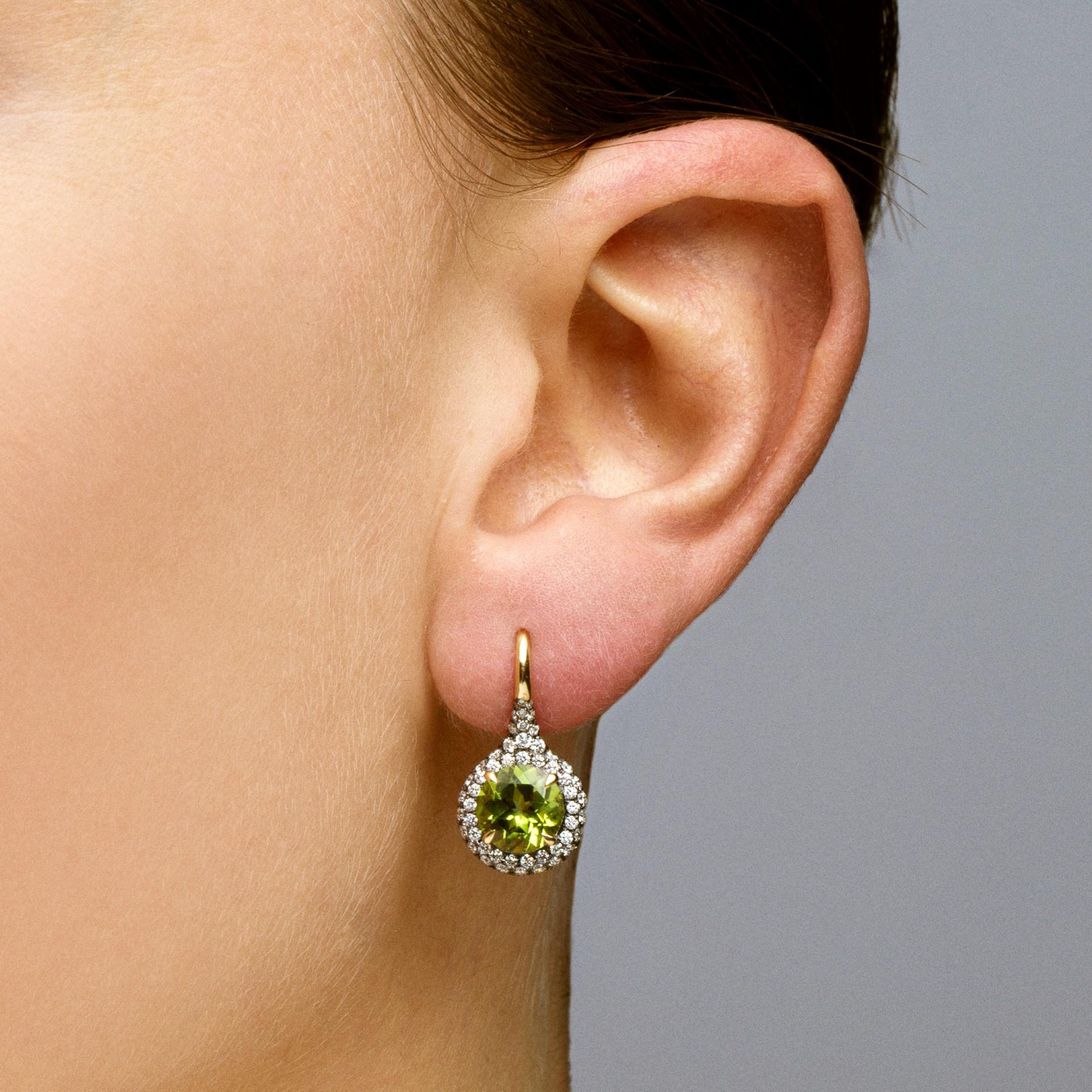 Alex Jona design collection, hand crafted in Italy, 18 karat yellow gold stud earrings set with two round cut peridot  weighing 4.12 carats, surrounded by 152 white diamonds, F color, VVS1 clarity, weighing 1.54 carats in total. 

Alex Jona jewels