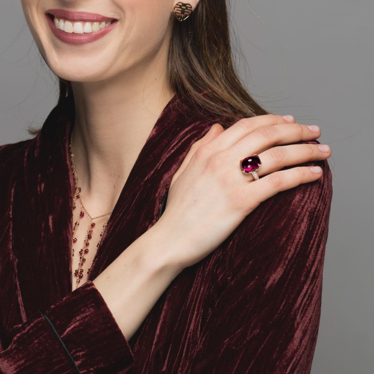 Alex Jona design collection, hand crafted in Italy, 18 karat white yellow gold ring, centering a 18 carat cabochon cut natural intense red Rubellite set with 120 diamonds, F color, VVS1 clarity, weighing 1.24 carats.
The rubellite is a particularly