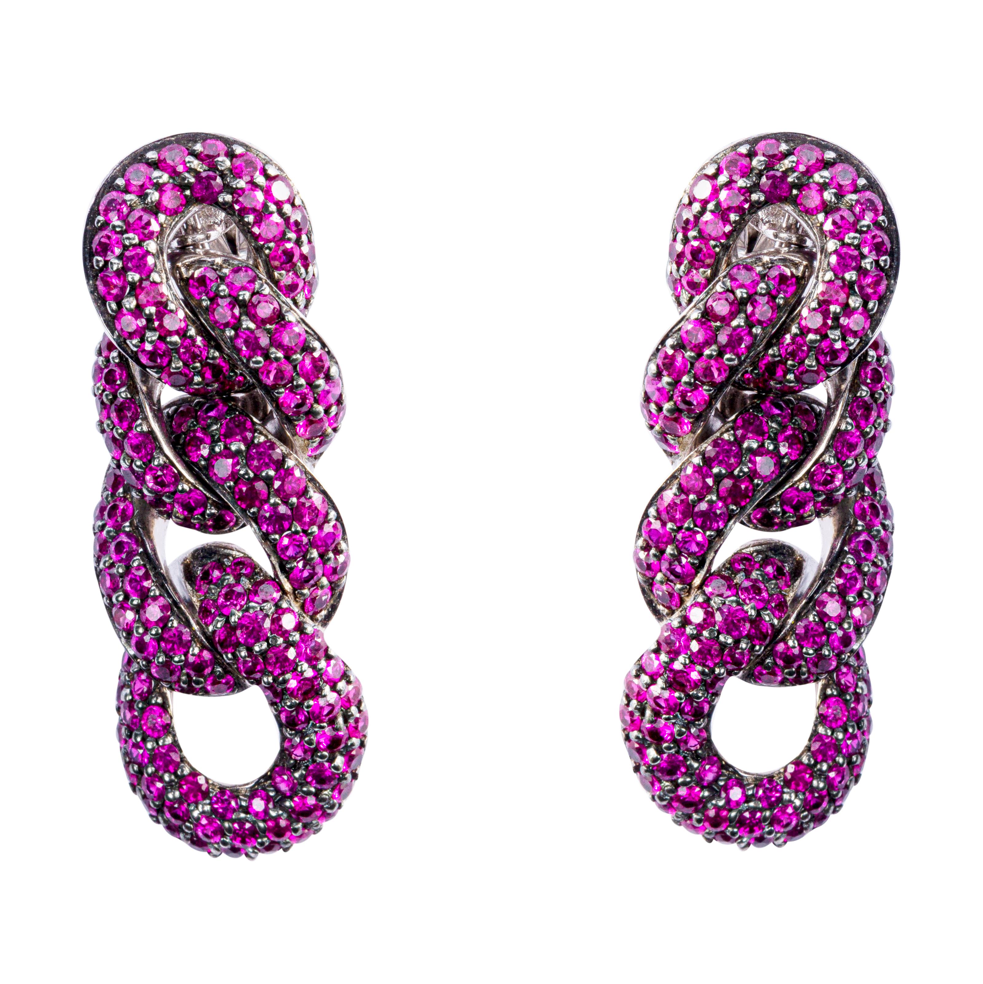 Alex Jona design collection, hand crafted in Italy, 18k white gold curb link chain clip earrings set with 4.58 carats of rubies with black rhodium setting. 
Dimensions: H x 34mm, W x 12mm, D x 5mm / H x 1.33in, W x 0.47in, D x 0.19in.
All Jona
