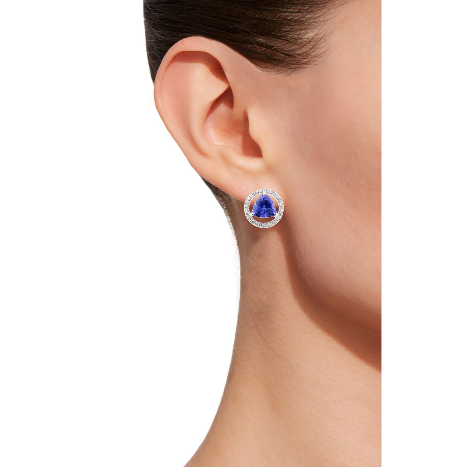 Alex Jona design collection, hand crafted in Italy, 18 karat white gold stud earrings set with two trillion cut Tanzanite weighing 3.94 carats, surrounded by 60 brilliant cut white diamonds, F color, VVS1 clarity, weighing 0.39 carats. Earrings