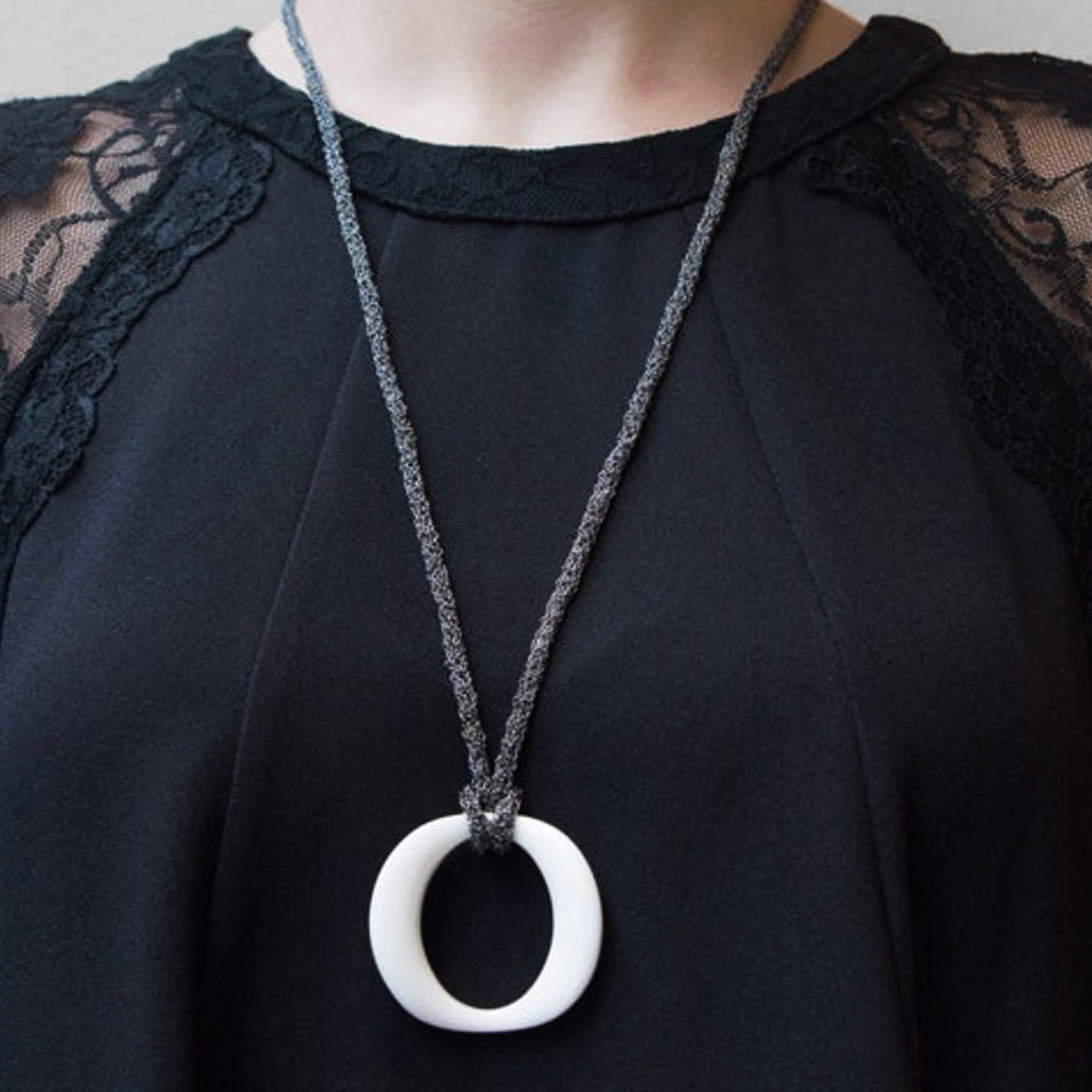 Alex Jona design collection, hand crafted in Italy, dark rhodium plate sterling silver long necklace, 35.43 inch- 90cm long, made of woven small chains knotted  with a white agate pendant, 1.70 inch-4.3cm diameter.

Alex Jona jewels stand out, not