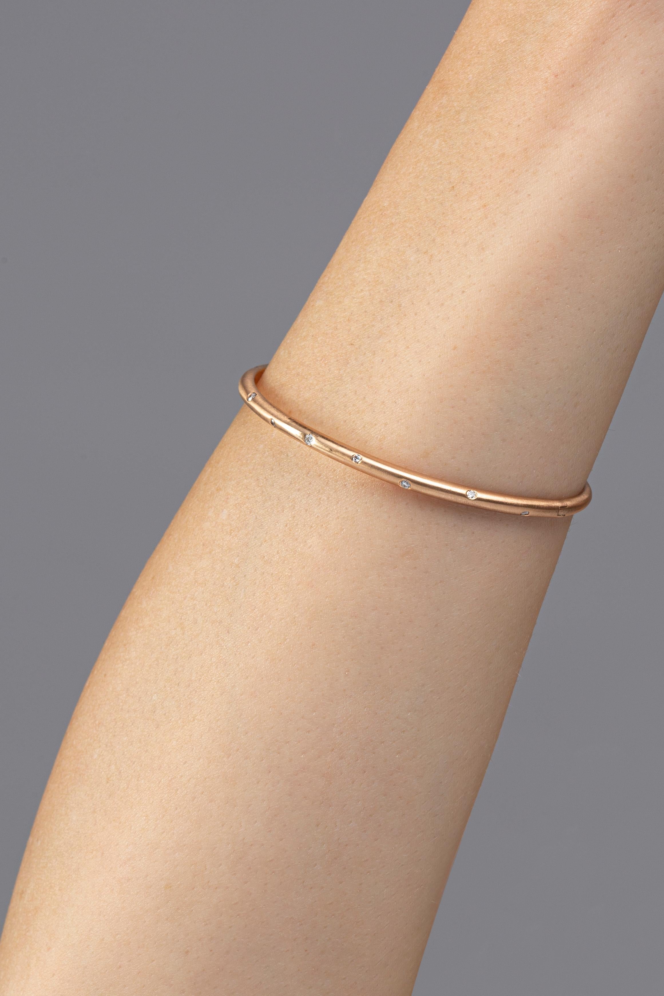 Alex Jona design collection, hand crafted in Italy, 18 karat brushed rose gold bangle bracelet with 9 white diamonds, weighing 0.14 carats in total.

Alex Jona jewels stand out, not only for their special design and for the excellent quality of the