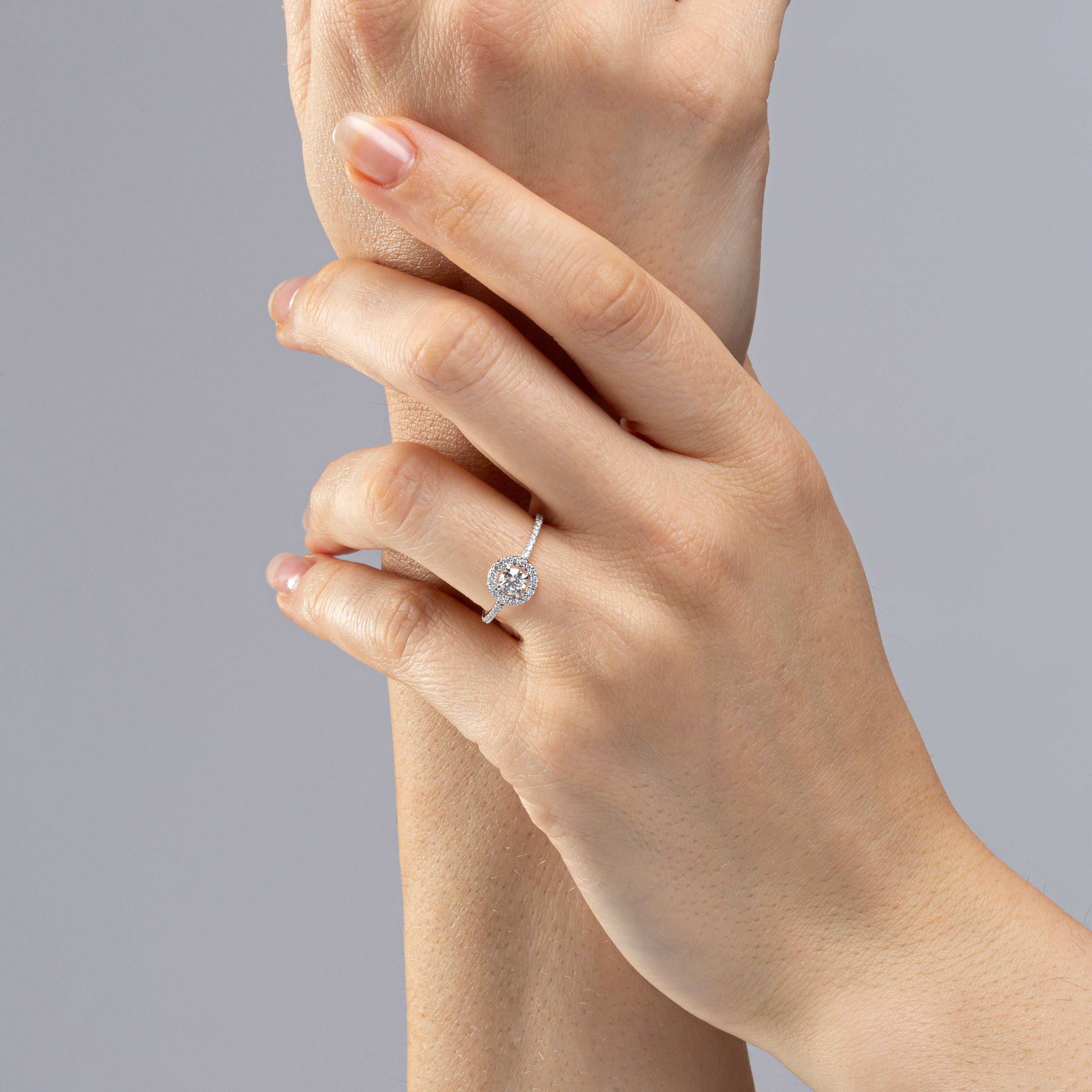 Alex Jona design collection, hand crafted in Italy, 18 Karat white gold ring, centering a round cut white diamond weighing 0.30 carats, surrounded by 47 round-cut diamonds weighing  0.23 carats, E-color/ VVS2-clarity. Signed Jona, ring Size: US 6