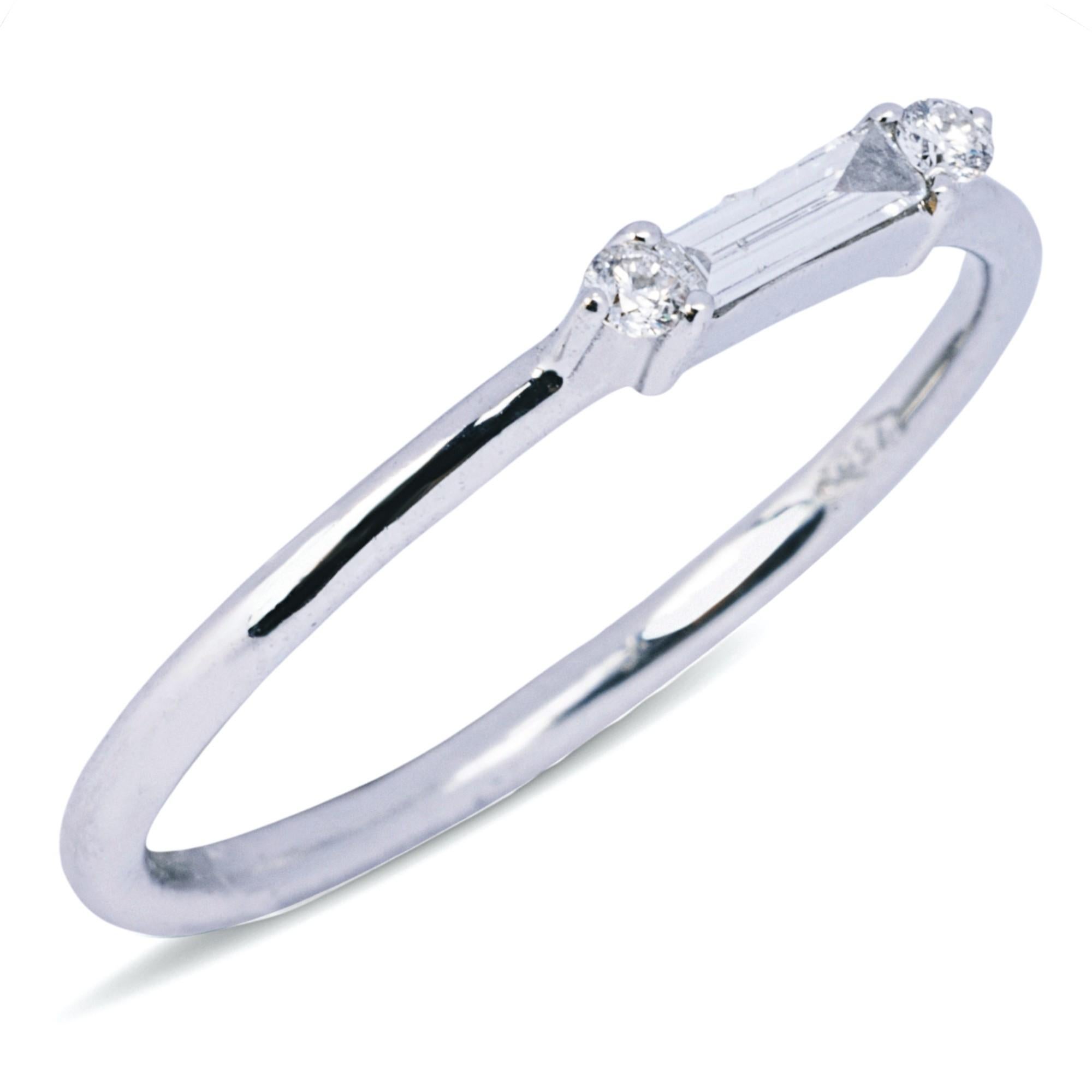 Alex Jona Design collection, hand crafted in Italy, 18 Karat white gold ring centering a baguette cut white diamond,  accented by two round white diamonds, weighing 0.11 total carats, F-G color, VS clarity.
Alex Jona jewels stand out, not only for