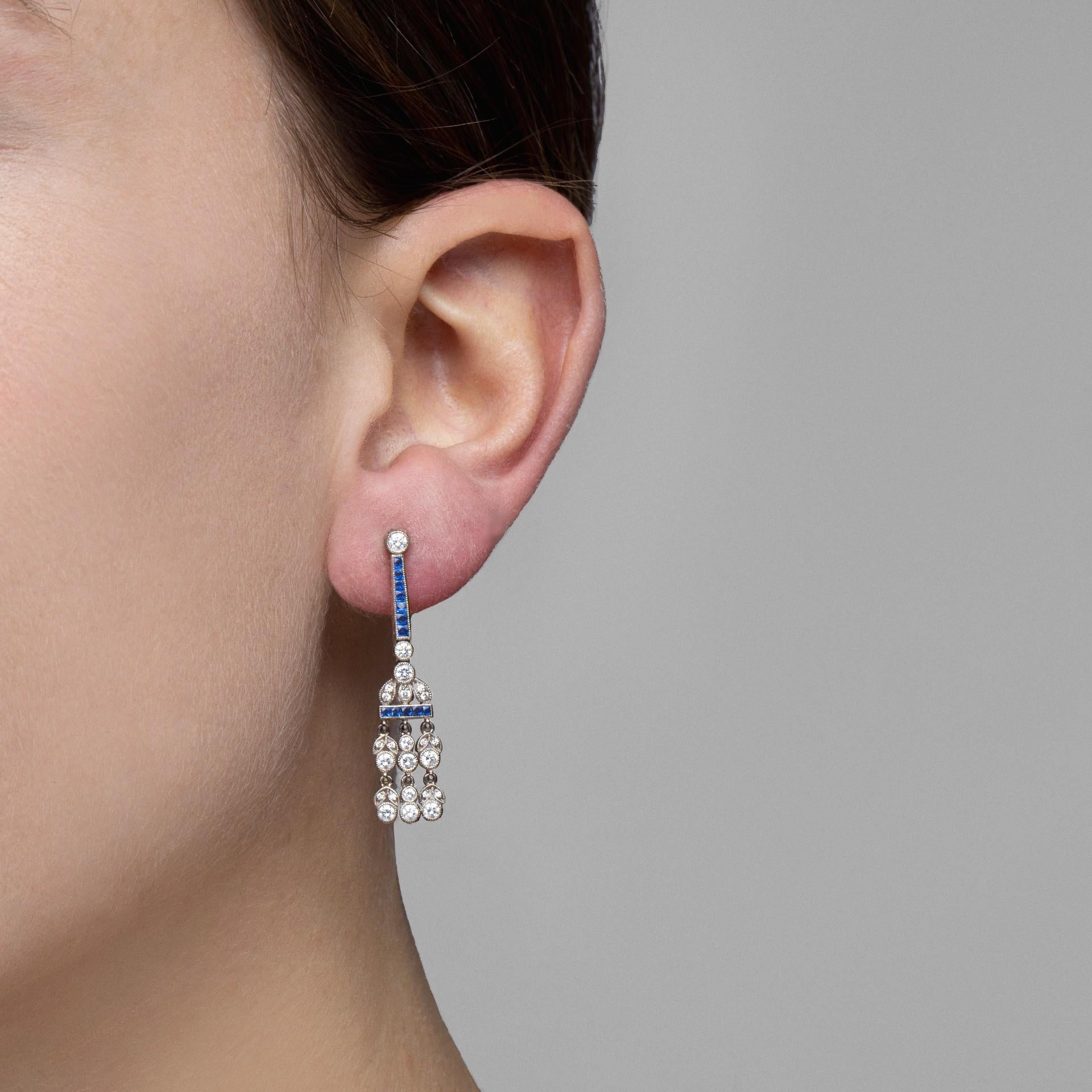 Alex Jona design collection, hand crafted in Italy, platinum dangling chandelier earrings, set with 1.02 carats of brilliant cut diamonds G Color, VVS Clarity and 0.93 carats of square cut blue sapphires. 
Dimensions: H x 38mm, W x 9mm, D x 2mm / H