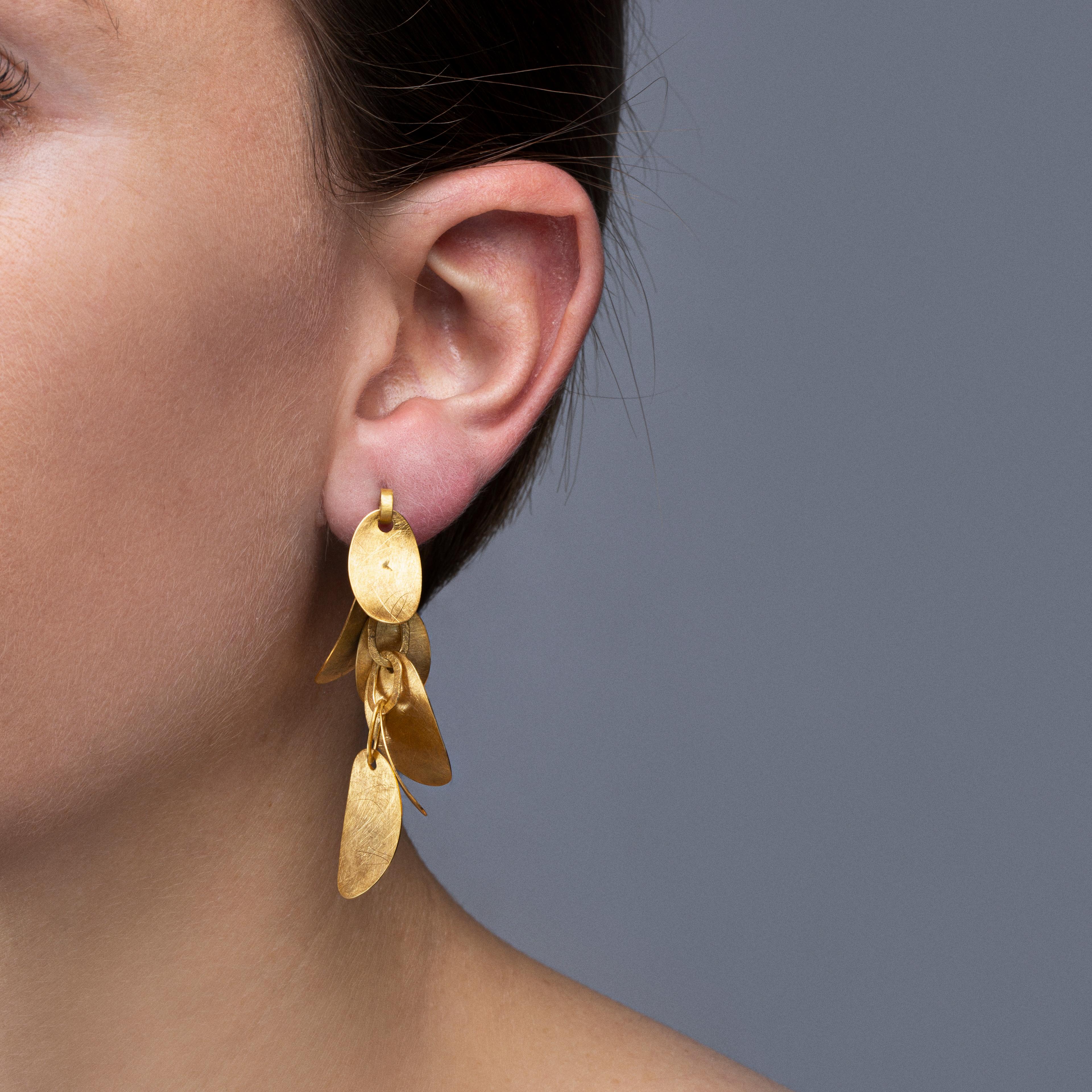 Alex Jona design collection, hand crafted in Italy, 18 karat rough frosted yellow gold multiple leaves pendant earrings.
Dimensions: H 1.9in/48mm, W 0.39in/9.9mm, D 0.23in/5.87mm.

Alex Jona jewels stand out, not only for their special design and