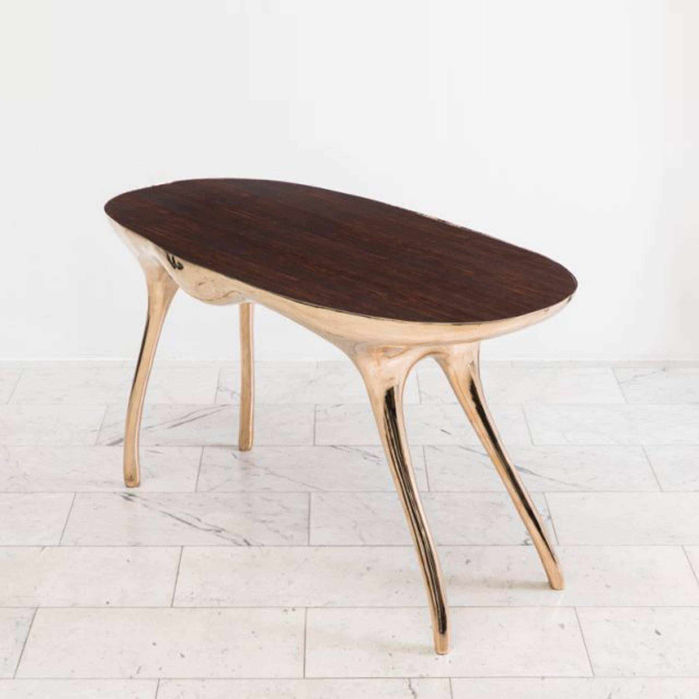 Inspired by Alex Roskin’s L’éléphant Console, the Biche Desk reflects the artist’s modernist and primitivist influences.

The desk’s muscular sculpted shape is cast in bronze, and polished to a mirror finish. The base of the table, bowed and