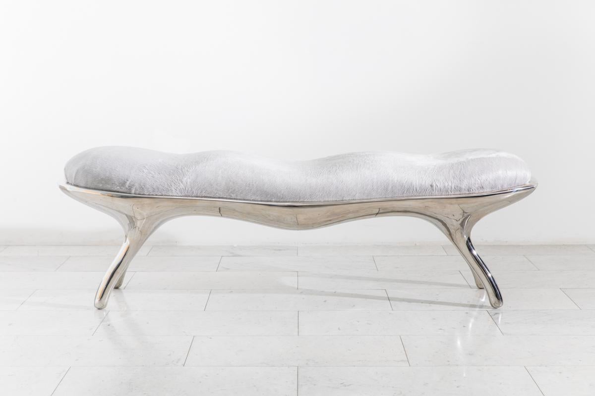 The Biche bench‘s muscular sculpted shape is cast in lightweight mirror-polished stainless steel. Upholstered in grey pony hair with silver metallic accents, the bench’s seat is contoured to contrast the belly of the bench.

Roskin’s works blend