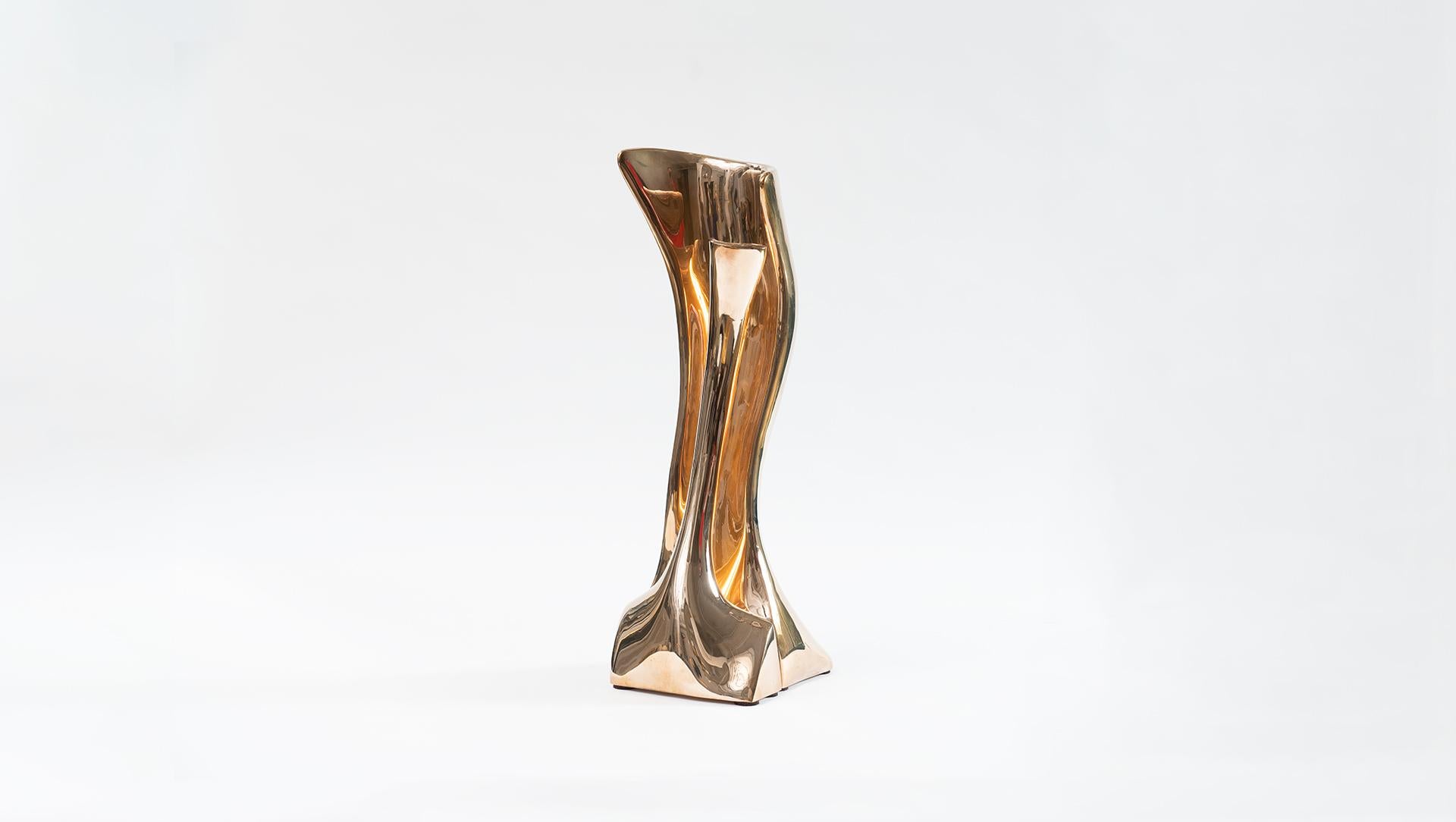 True to form, Alex Roskin’s LED sculptural lamp, in brass, has the same perfectly proportioned curves as his unique bronze and steel furniture pieces. Internal LEDs bounce off of the polished brass, giving the work a warm, glow that punctuates its