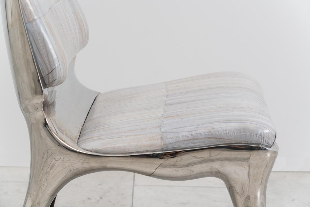 The tusk chair demonstrates Roskin’s propensity for an animality in form. Created in mirror-polished stainless steel, the chair features a low seat and wide back, balancing masculine and feminine elements with forms that are active, powerful, and