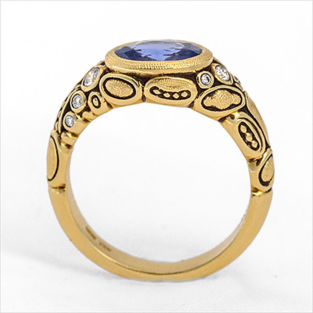 From the studio of Alex Sepkus in New York - 18 karat yellow gold ring with stunning oval shaped vivid blue sapphire and set with 10 brilliant cut white diamonds. This ring is of heirloom quality you love and expect from Alex Sepkus.

Blue sapphire