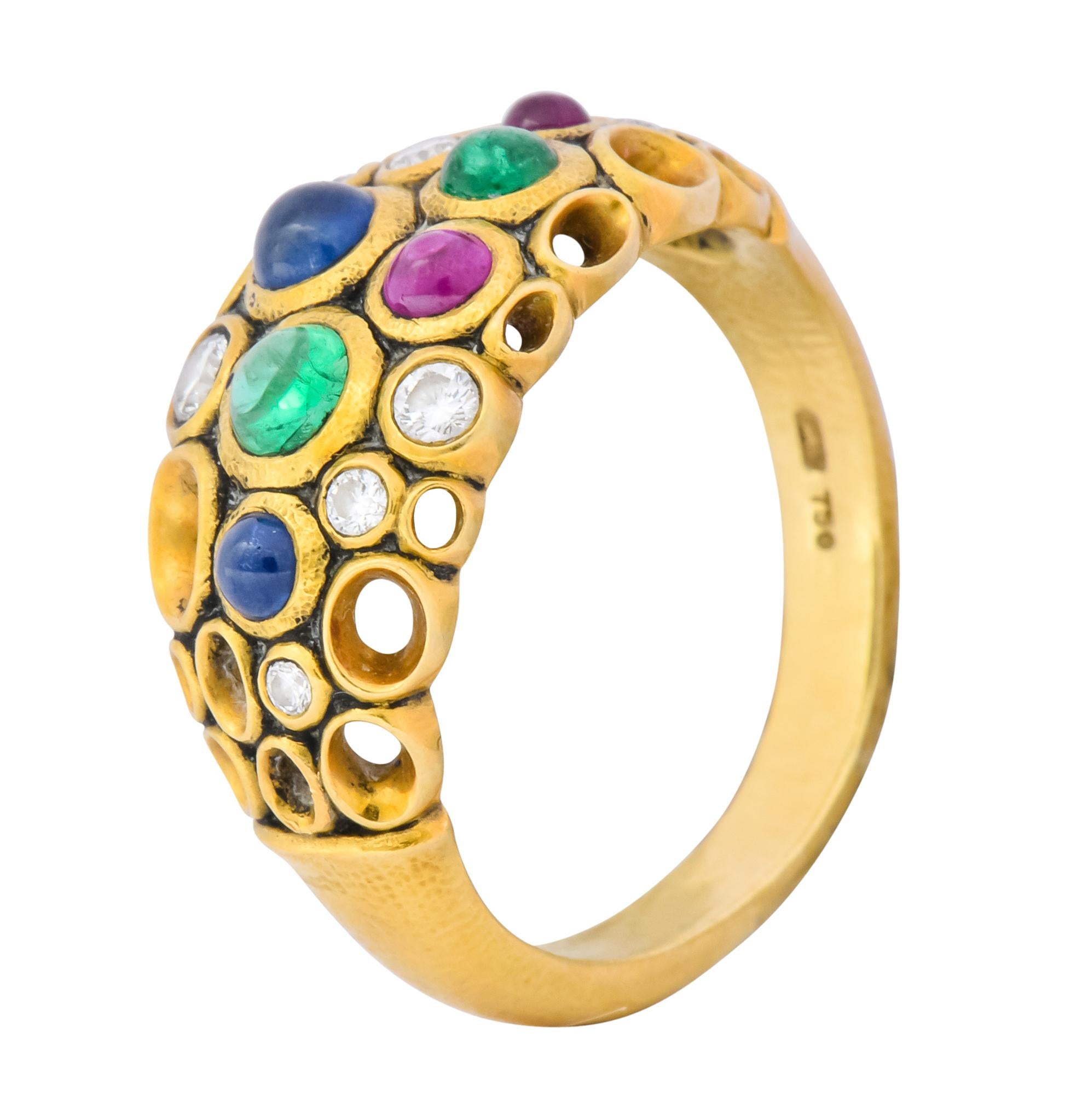 Bubble style ring bezel set throughout with round brilliant cut diamonds, cabochon rubies, emeralds and sapphires weighing approximately 0.65 carat total

With negative space motif and stippled finish

Fully signed Alex Sepkus and stamped 750 for 18