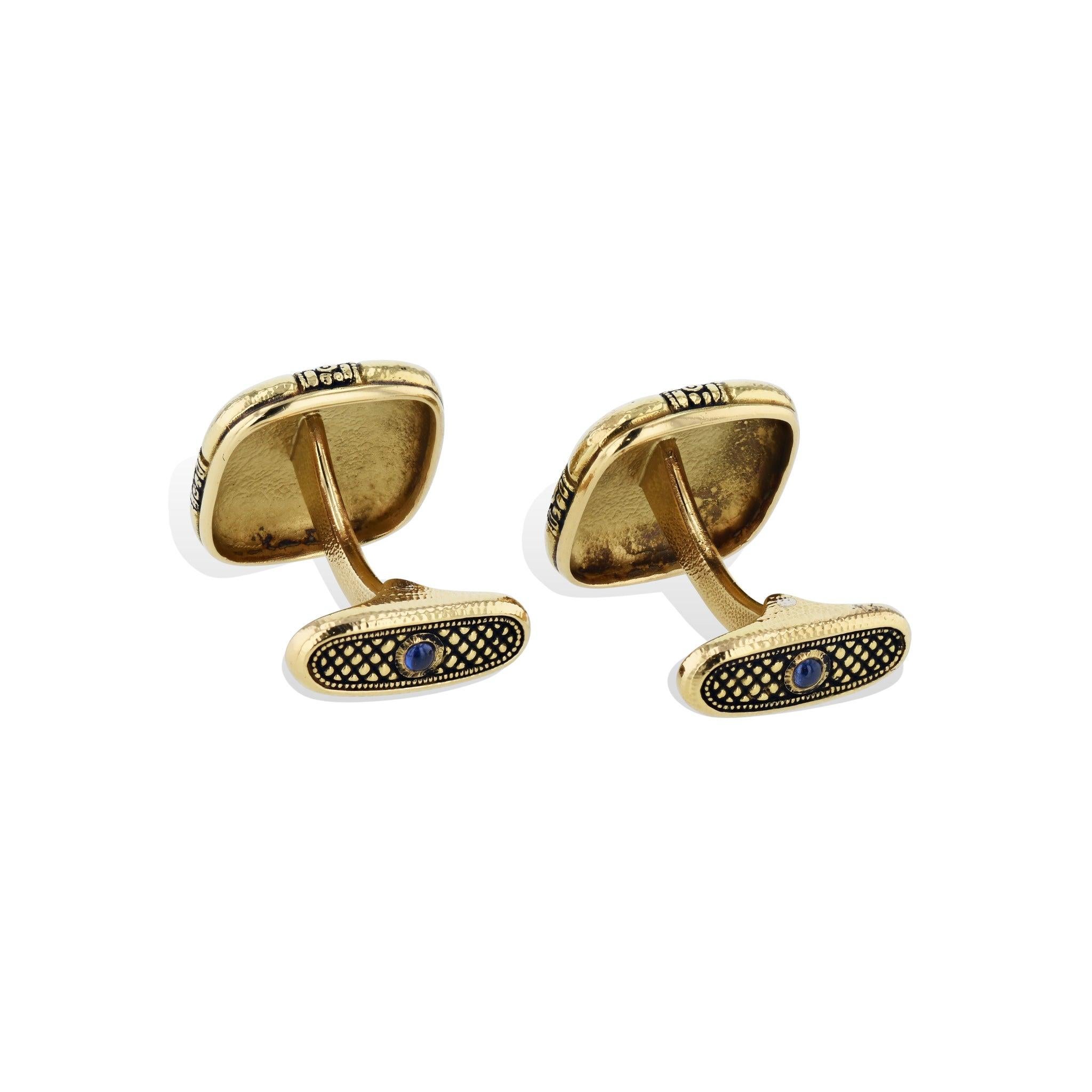 Unlock timeless luxury with these daring Alex Sepkus 18kt. Yellow Gold Ribbon Cufflinks Featuring stunning Blue Sapphire cabochons from the H&H esteemed Estate Collection. For those who appreciate a timeless classic, these cufflinks are an opulent