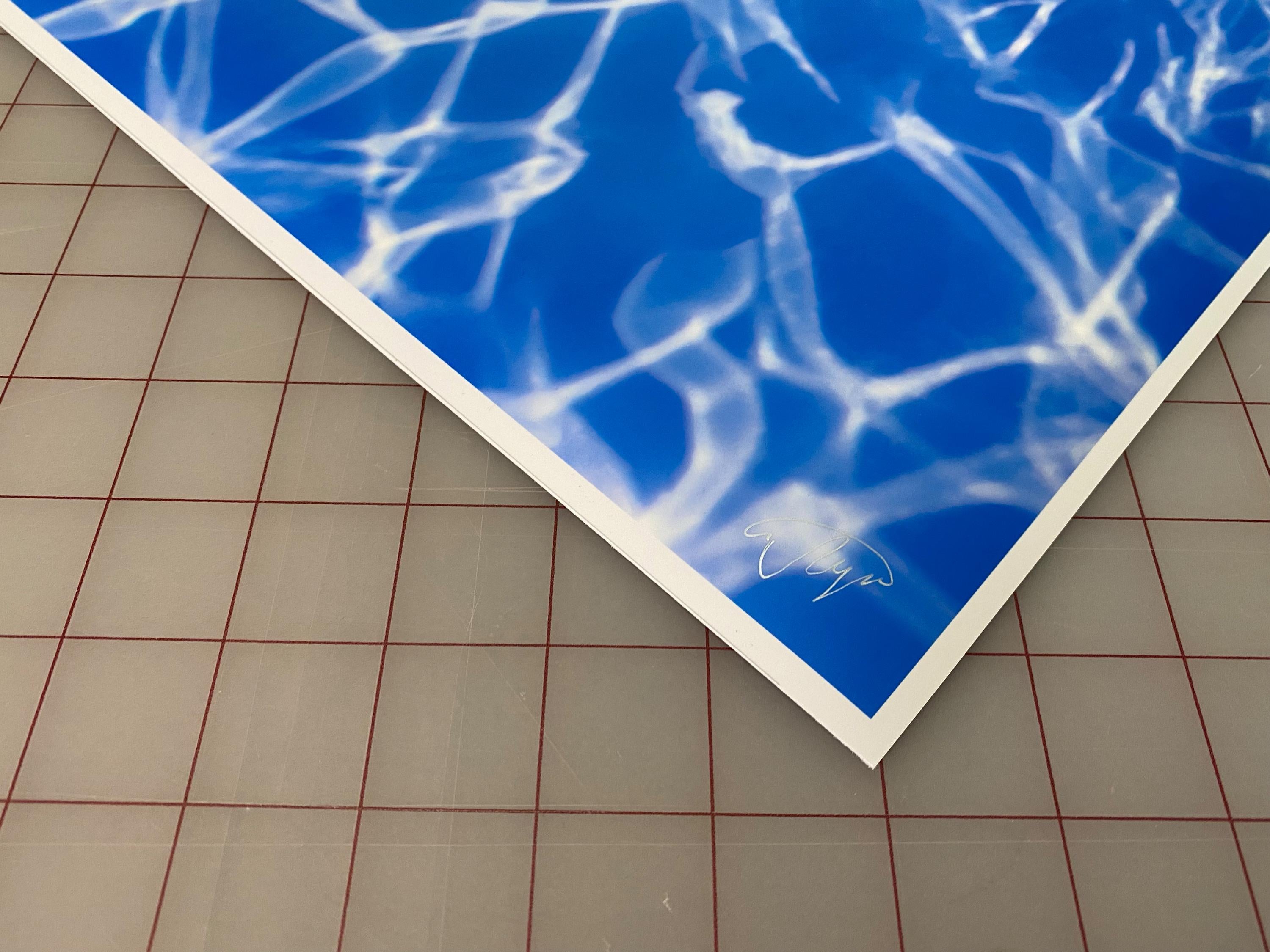 An underwater photograph of a beautiful naked model at the bottom of a pool. The photograph has powerful color schema floating from blue to magenta.  

Original gallery quality archival pigment print signed by the artist.
Limited edition of 24.
The