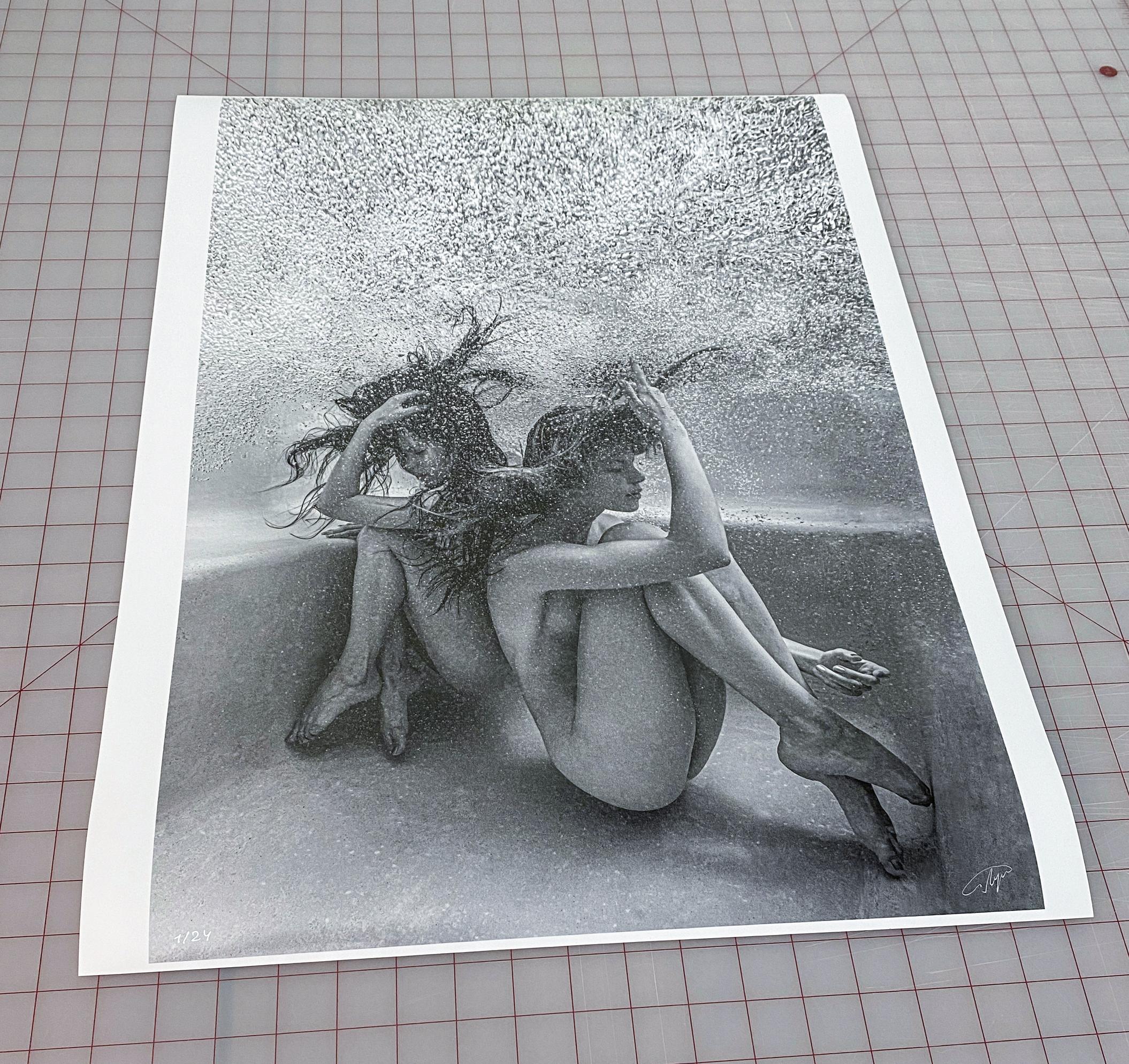 Underwater black & white photograph of two young naked women wrapped in air bubbles.

Original gallery quality archival pigment print signed by the artist.
Limited edition of 24 
Paper size: 53x36