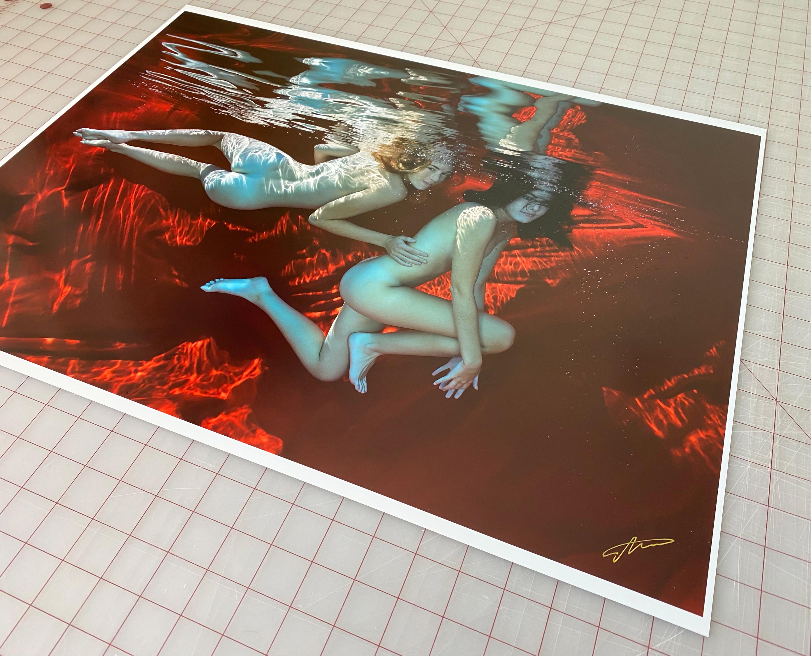An underwater photograph of two naked models on red background.

Original gallery quality digital archival pigment print on archival paper signed by the artist. 
Limited edition of 24
The artwork is furnished with certificate of authenticity with