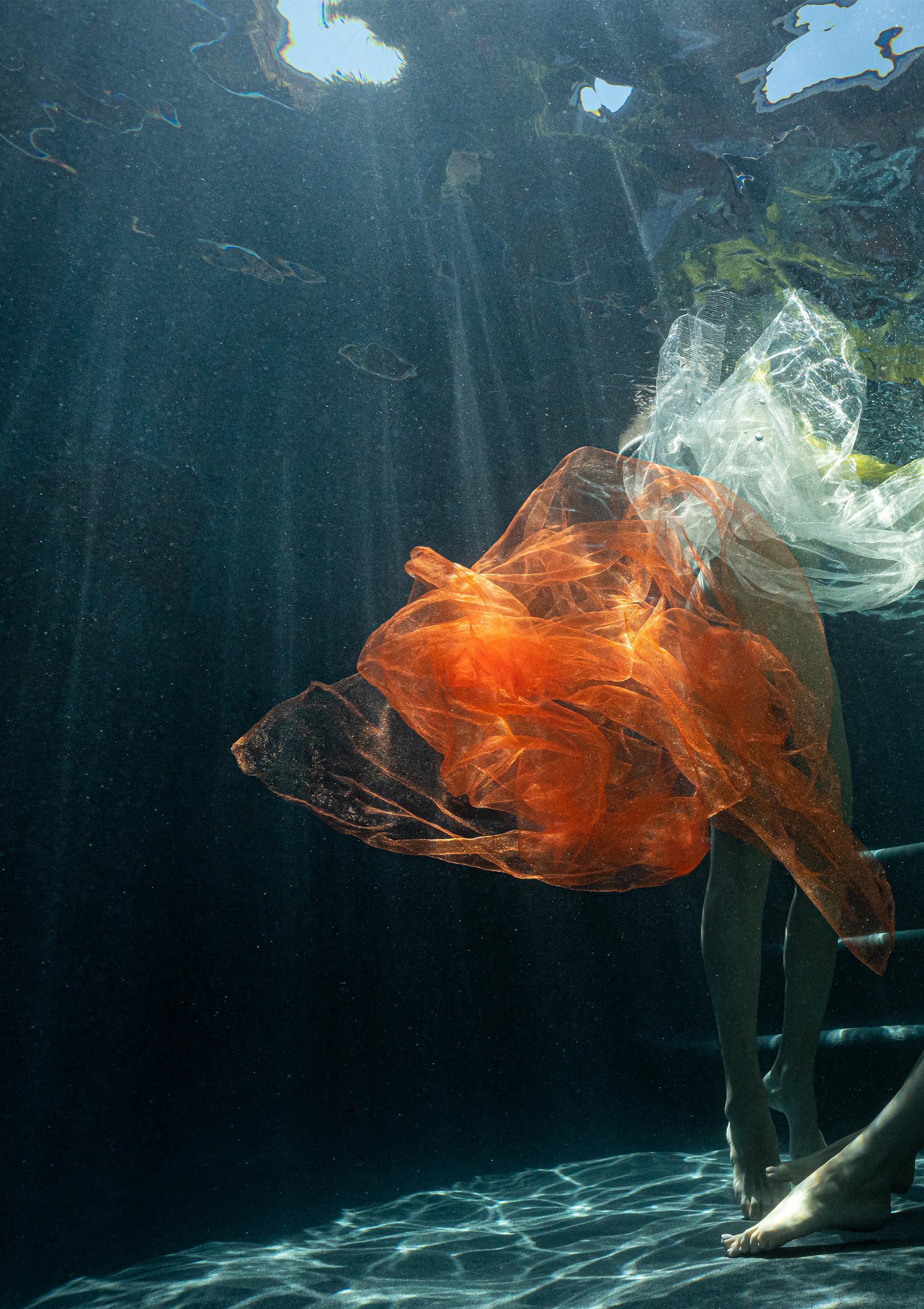 Underwater nude photograph of two models partially covered with bright tulle scarfs

Original gallery quality print on archival metallic paper signed by the artist.
Paper size: 18