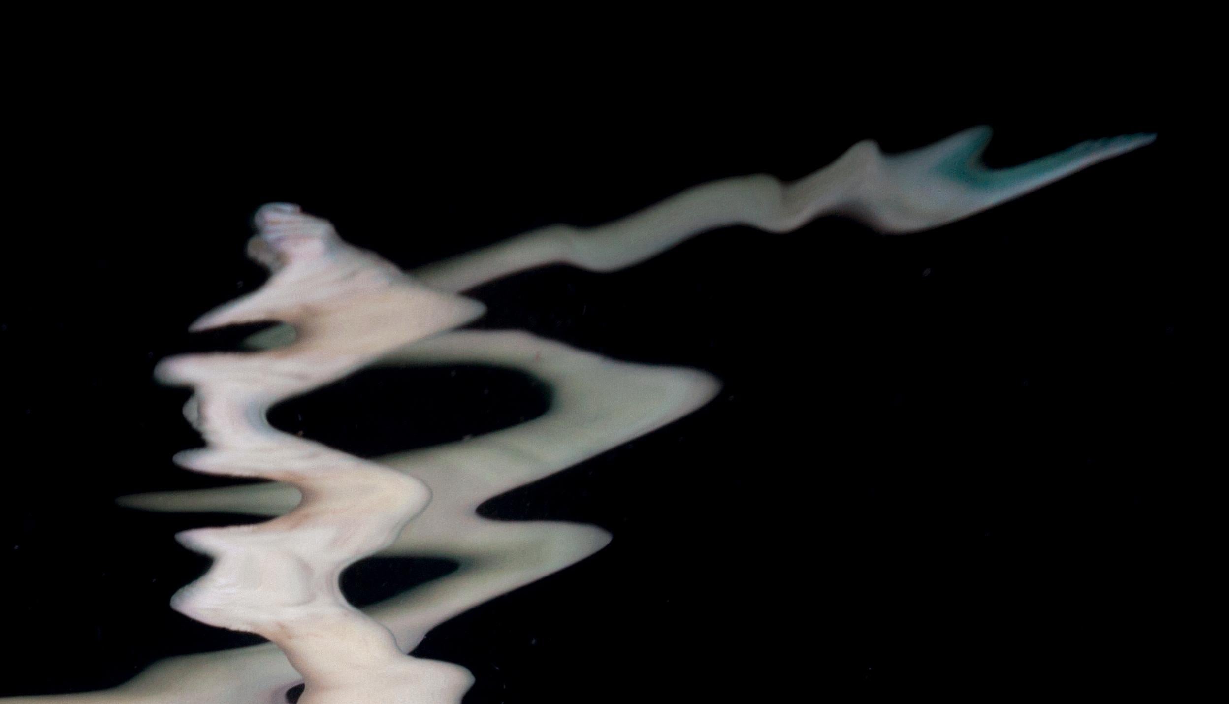 An underwater photograph of a naked young woman on neutral black background. 

Porcelain - aside from being an exquisite material - is the name of my project. The premise of the project: my best underwater photos in a porcelain color scheme on a