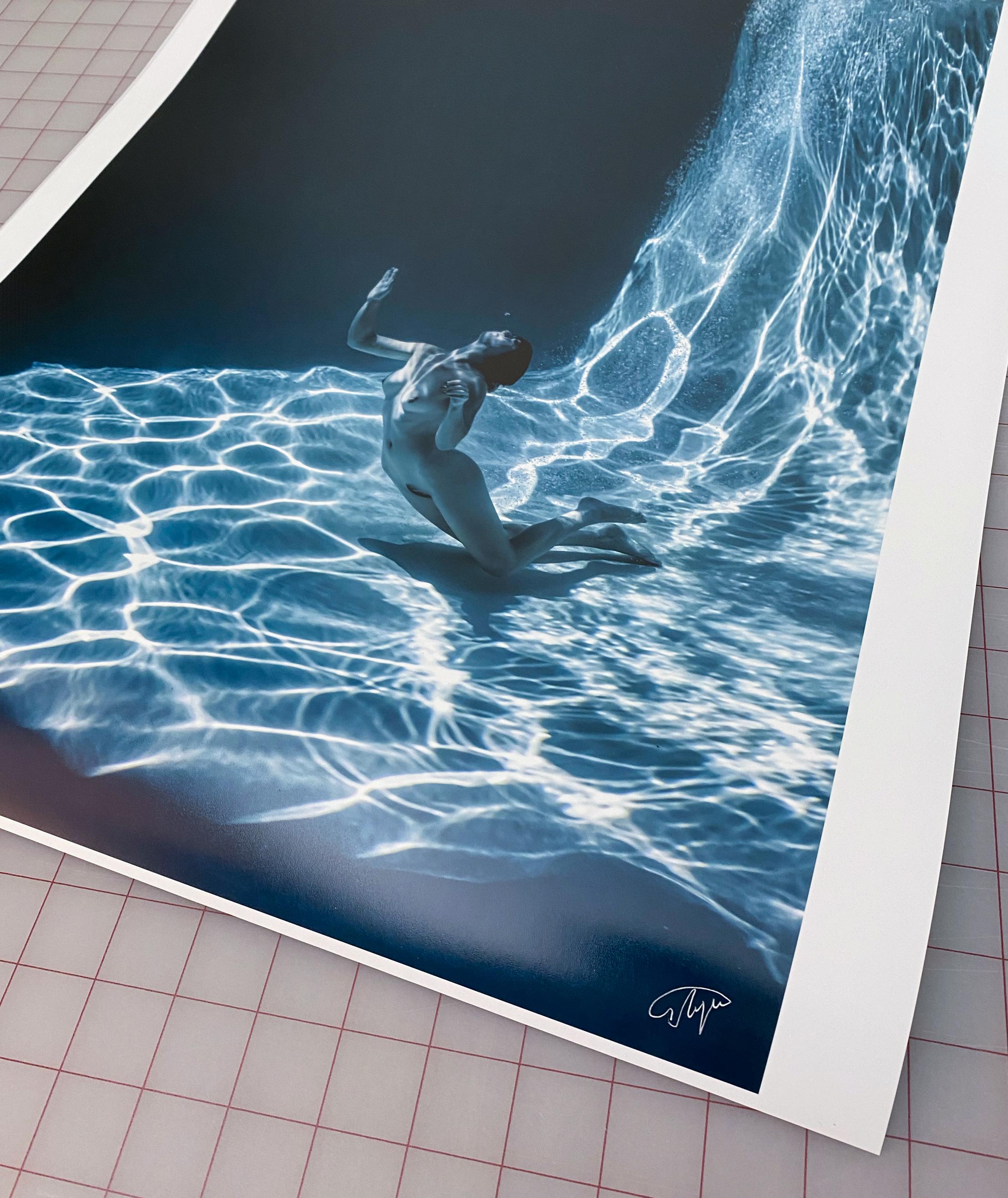 A beautiful  and mysterious underwater photograph of a young naked woman ascending from the bottom of her pool toward the air and light. This monochromatic aquatic tint photograph is a part of the series Marble Cave.

Original gallery quality