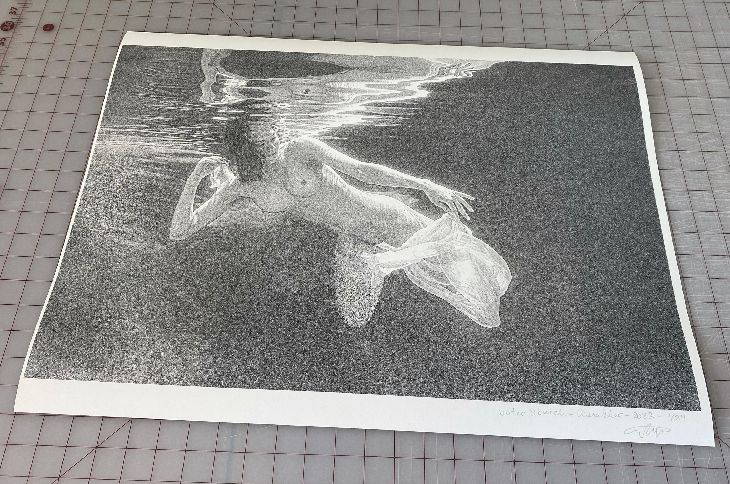Underwater black and white photograph of a young naked woman diving in a pool. The photograph is printed with high grain texture - as you may see on close up fragments.

Original gallery quality archival pigment print on archival 16 mil (300 g/m2)