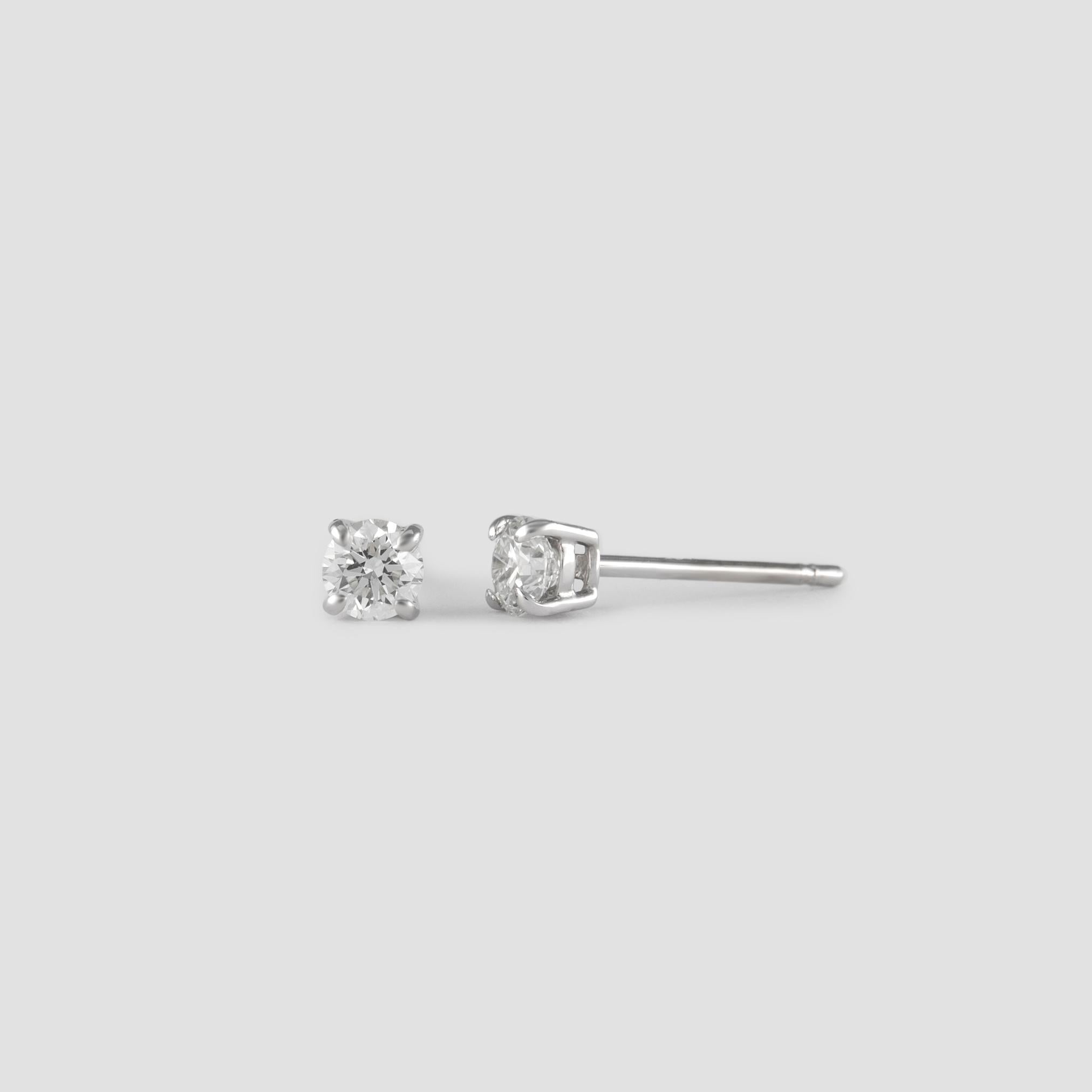 Classic diamond stud earrings. By Alexander of Beverly Hills.
Two round brilliant diamonds 0.30 carats total. Approximately G/H color and SI1 clarity. Four prong set, 14k white gold. 
Accommodated with an up to date appraisal by a GIA G.G., please