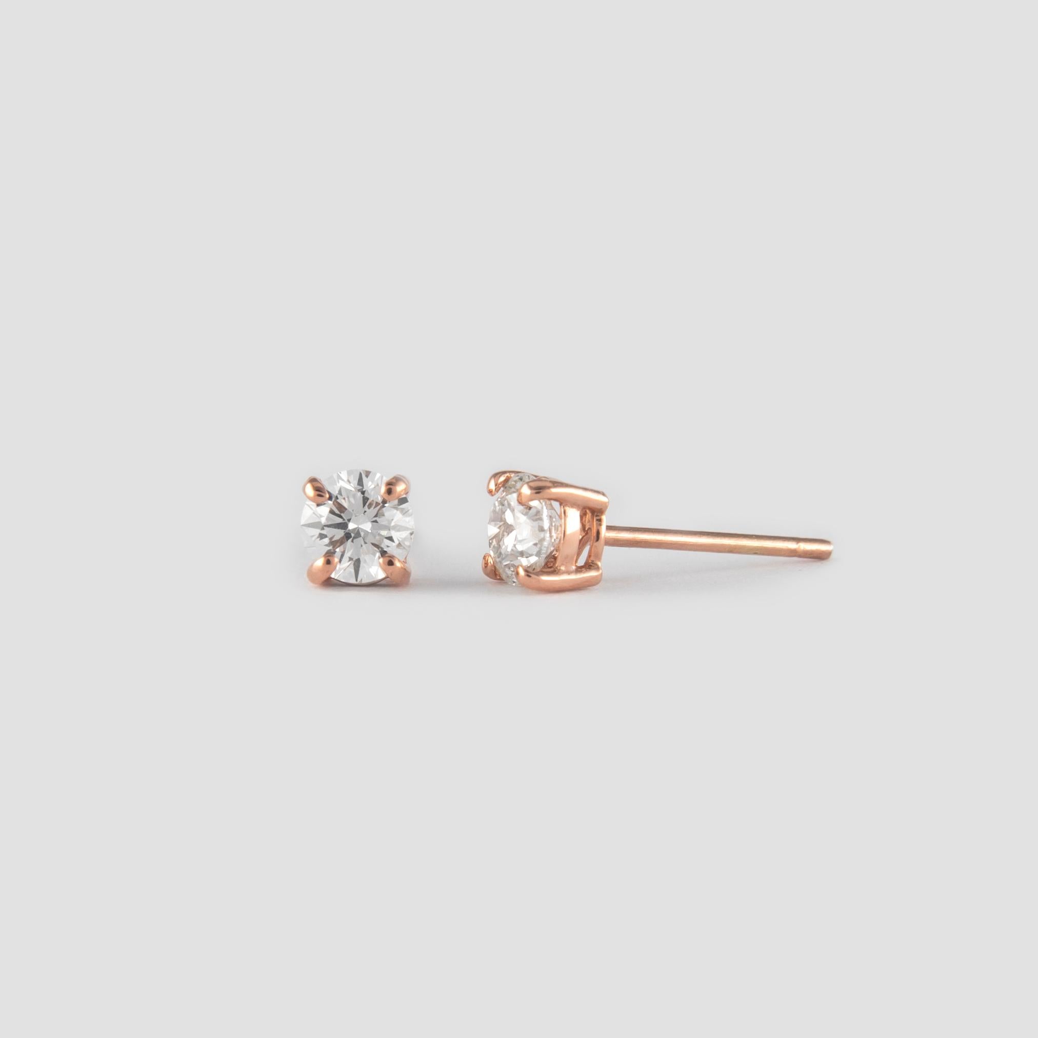 Classic diamond stud earrings. By Alexander of Beverly Hills.
Two round brilliant diamonds 0.92 carats total. Approximately G/H color and VS clarity. Four prong set, 14k rose gold. 
Accommodated with an up to date appraisal by a GIA G.G., please