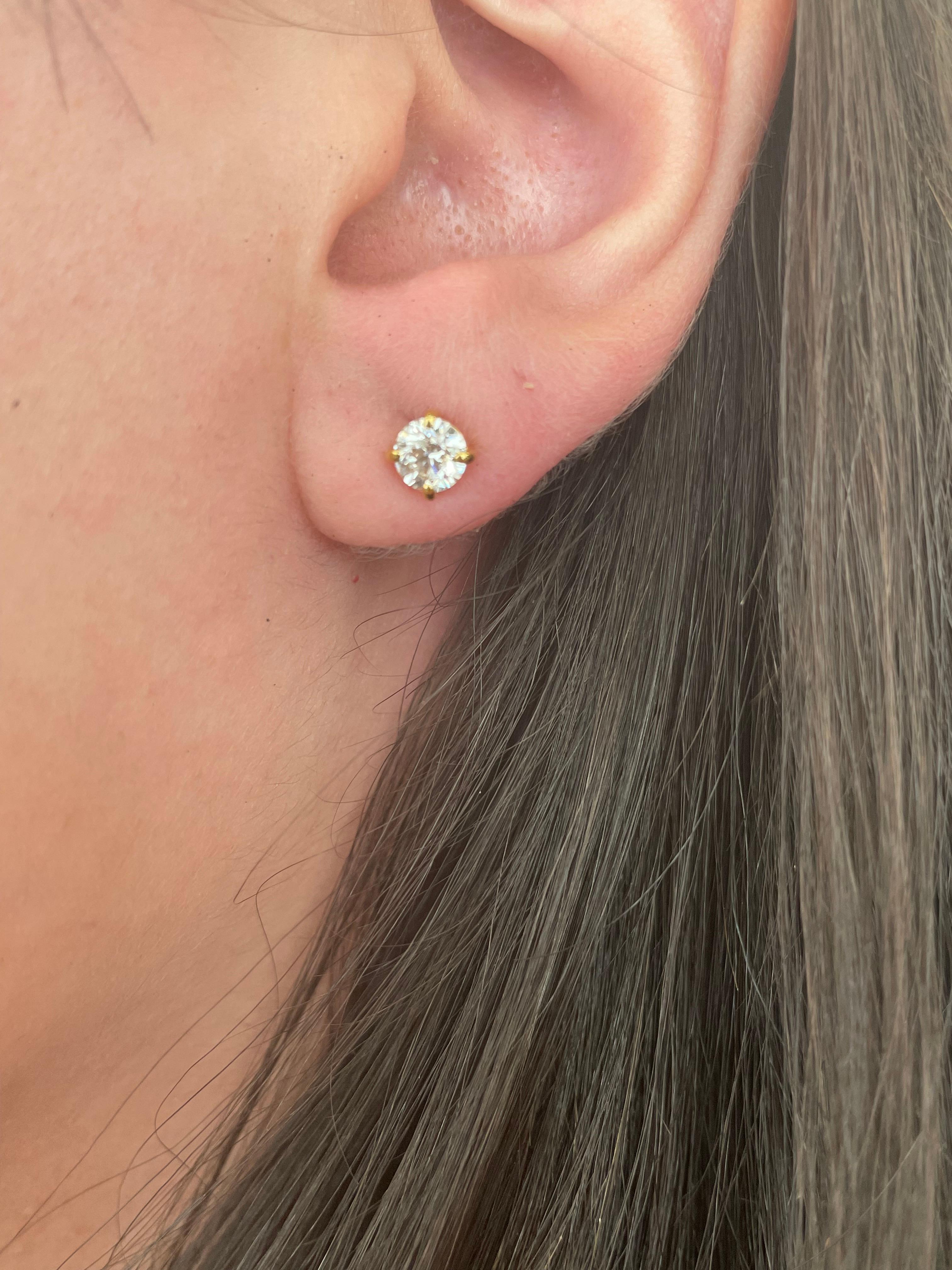 Classic diamond stud earrings. By Alexander Beverly Hills.
Two round brilliant diamonds 0.92 carats total. Approximately G/H color and SI clarity. Four prong set, 14k yellow gold. 
Accommodated with an up-to-date appraisal by a GIA G.G. once