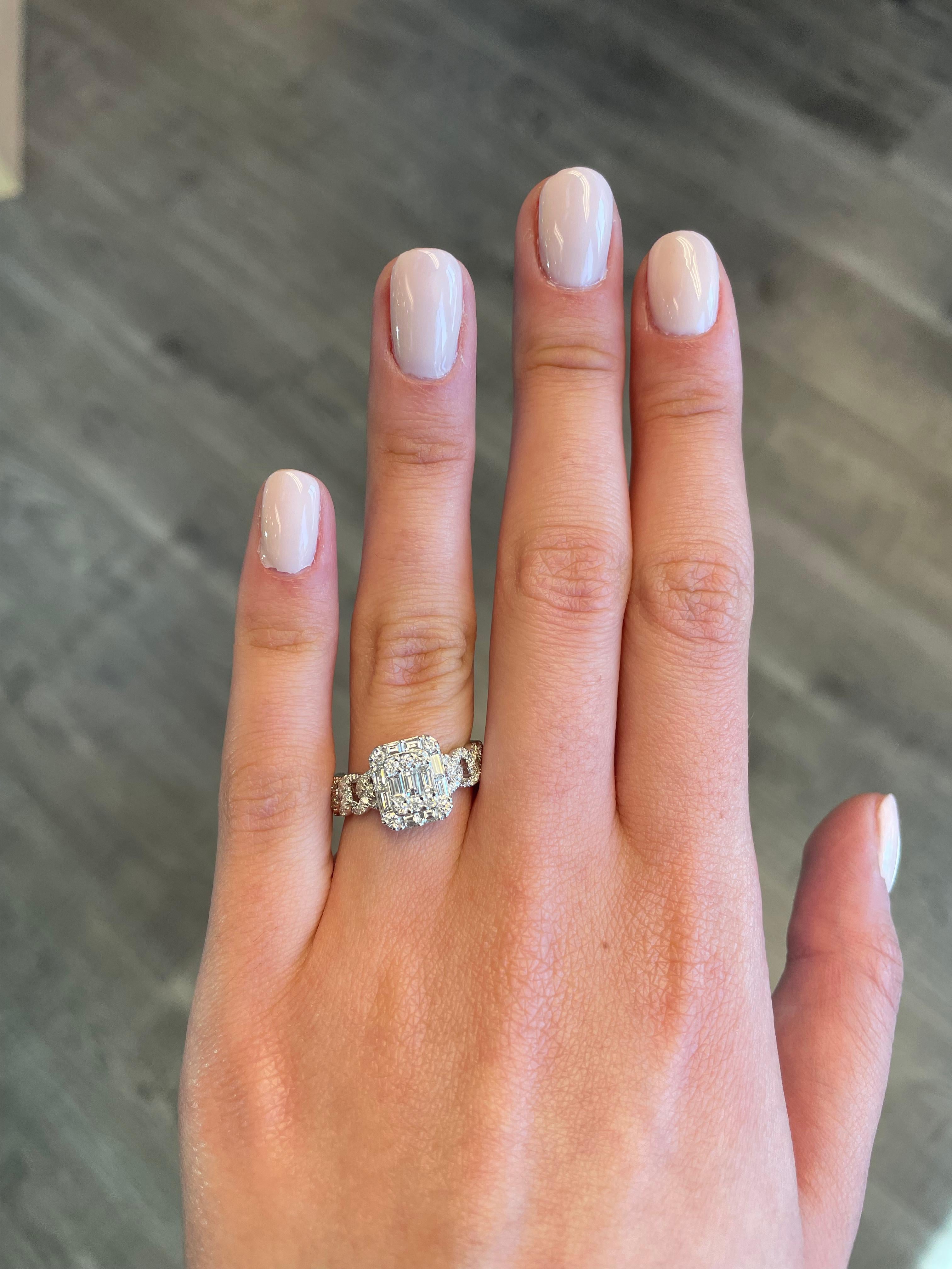 Stunning modern and unique illusion diamond ring. Set to look like an emerald cut diamond and cuban link wrap. By Alexander of Beverly Hills.
1.02 carats of round and baguette cut diamonds, approximately G/H color and VS2/SI1 clarity. 18-karat white