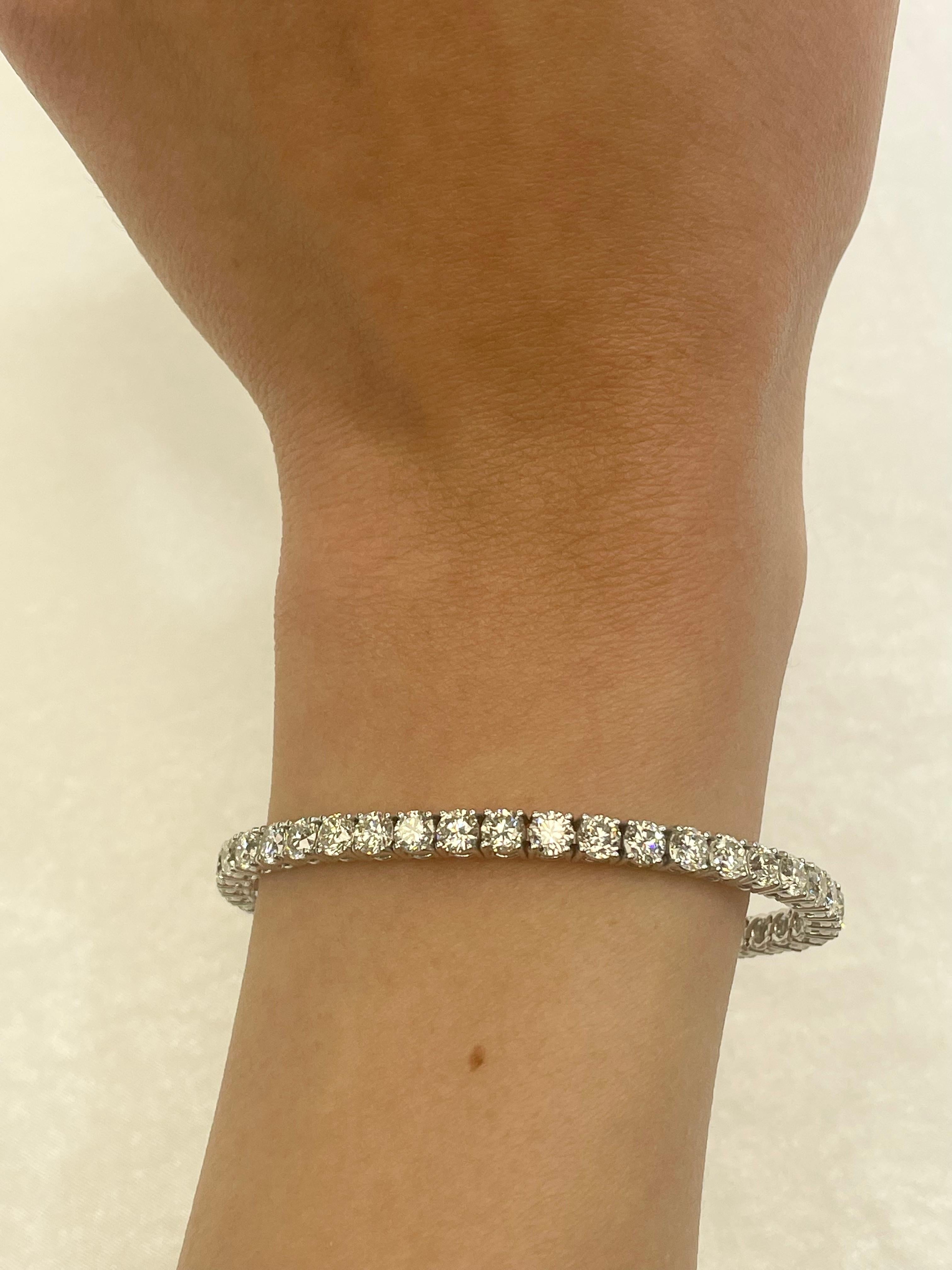 Exquisite and timeless diamonds tennis bracelet, by Alexander Beverly Hills.
42 round brilliant diamonds, 10.70 carats total. Approximately H/I color and VS clarity. Four prong set in 18k white gold, 16.08 grams, 7 inches. 
Accommodated with an up