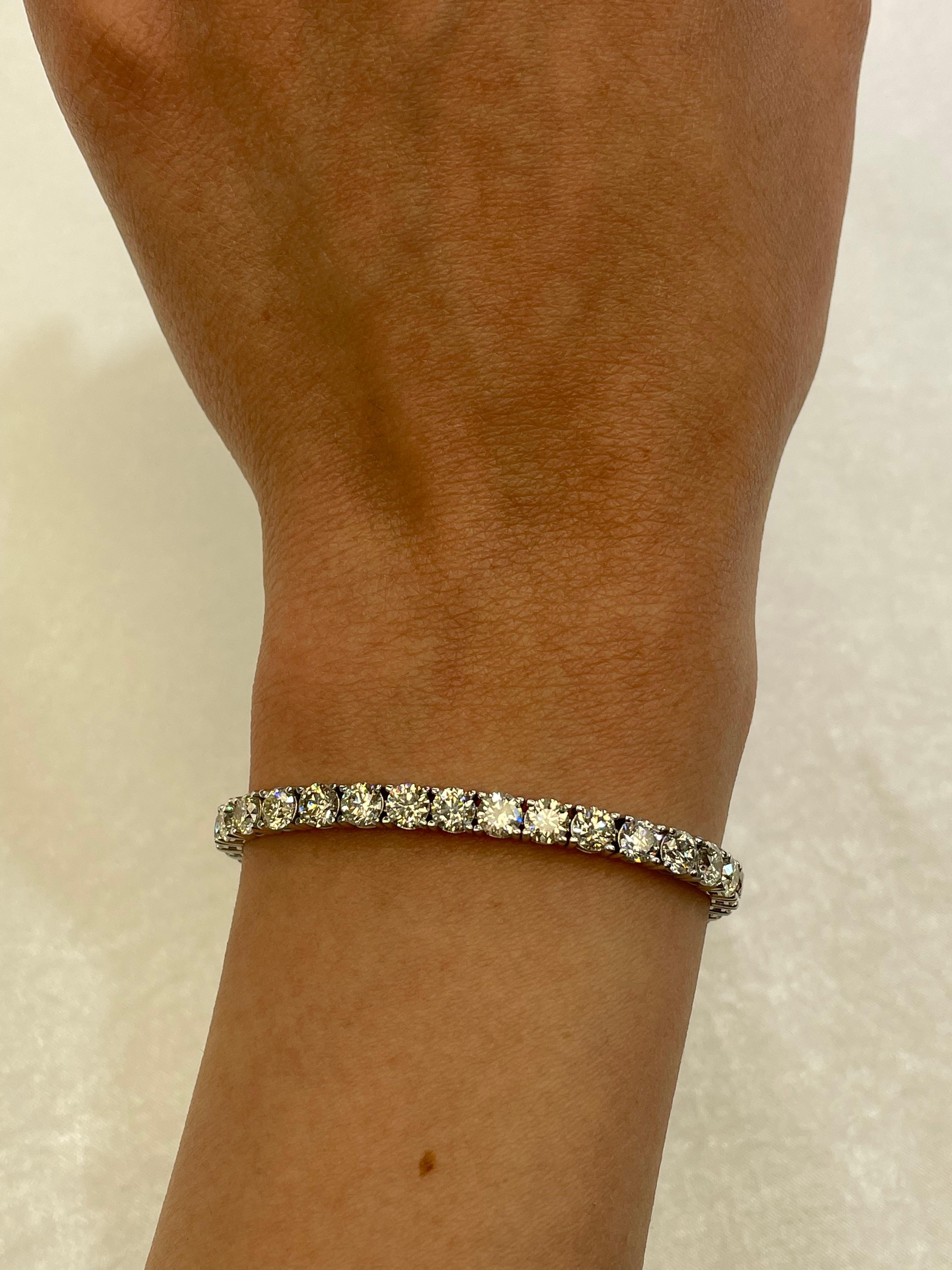 Exquisite and timeless diamonds tennis bracelet, by Alexander Beverly Hills.
40 round brilliant diamonds, 12.11 carats total. Approximately H/I color and VS clarity. Four prong set in 14k white gold, 11.42 grams, 7 inches. 
Accommodated with an up